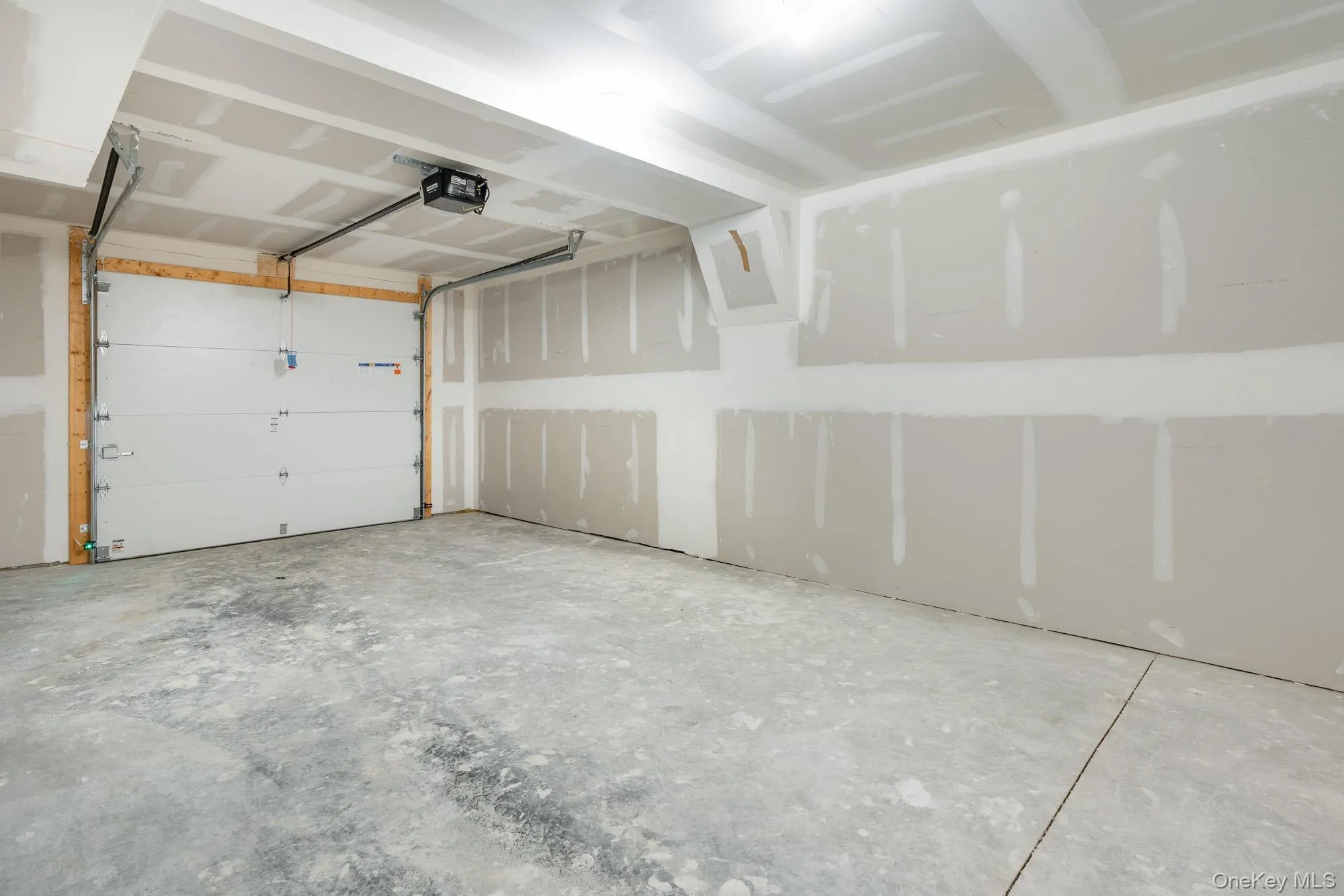 1 car Garage featuring a garage door opener and EV charger hook-up 1 car Garage featuring a garage door opener and EV charger hook-up