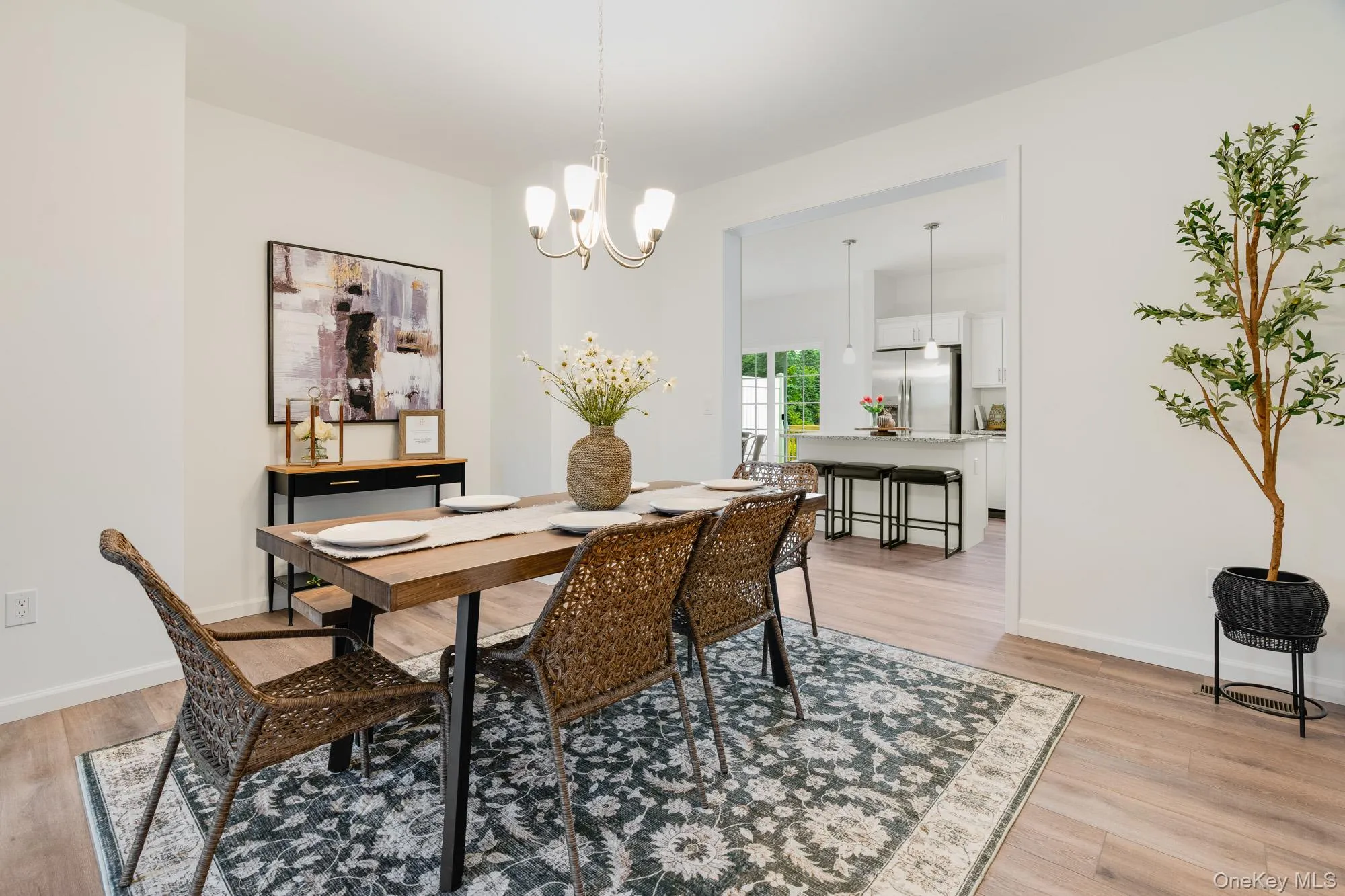 Dining space with light wood finished floors, a chandelier Dining space with light wood finished floors, a chandelier