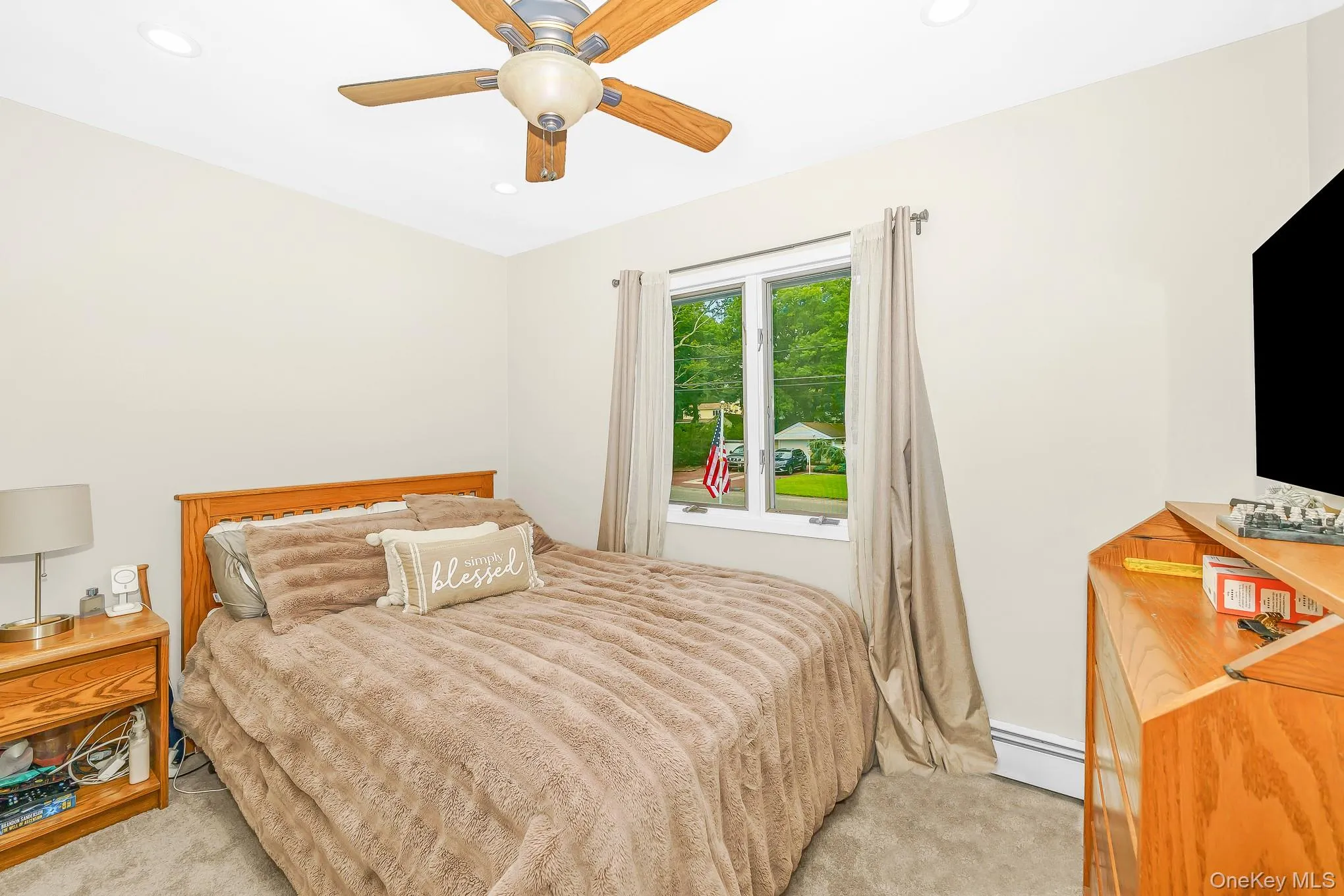 Recessed lighting, wood-finish ceiling fan, window with exterior exposure, and carpeted flooring Recessed lighting, wood-finish ceiling fan, window with exterior exposure, and carpeted flooring