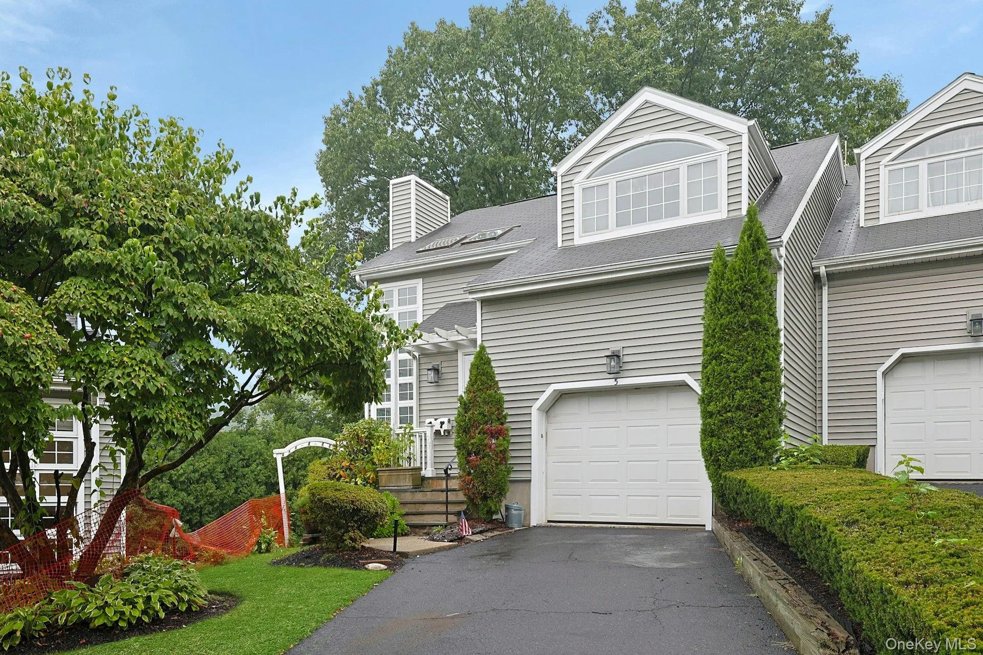 Siding exterior with dormer windows, attached garage, and driveway for 1 car Siding exterior with dormer windows, attached garage, and driveway for 1 car