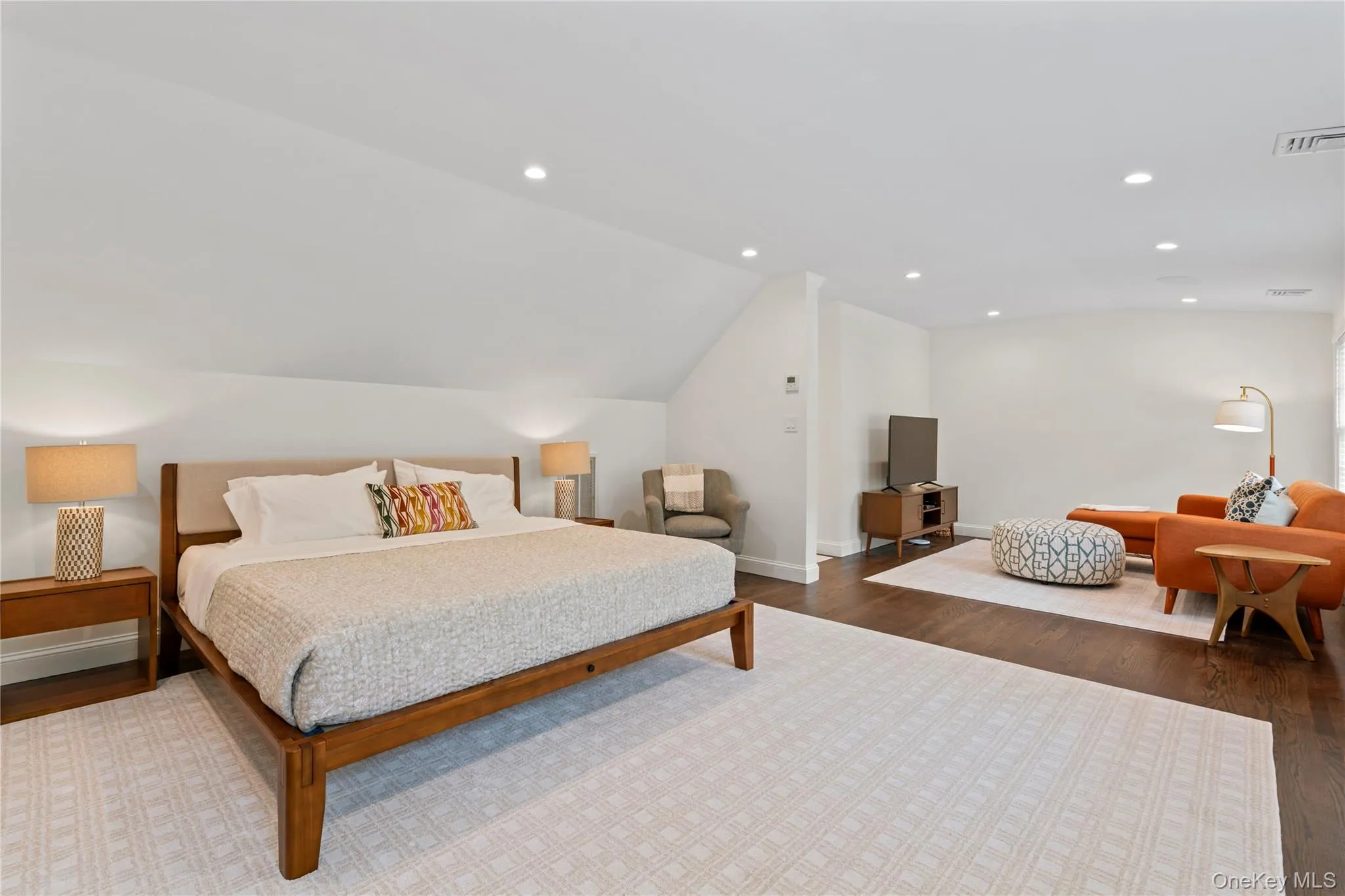 Guest Bedroom featuring Lofted Ceiling, Wood Finished Floors, Baseboards, and Recessed Lighting Guest Bedroom featuring Lofted Ceiling, Wood Finished Floors, Baseboards, and Recessed Lighting