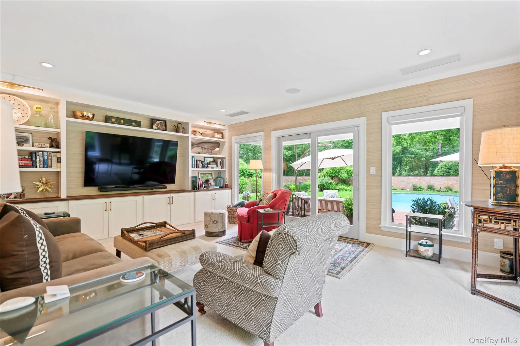 Adjacent to the living room is the cozy Sun room situated off the living room with sliding doors leading to the outdoor patio and pool. Adjacent to the living room is the cozy Sun room situated off the living room with sliding doors leading to the outdoor patio and pool.