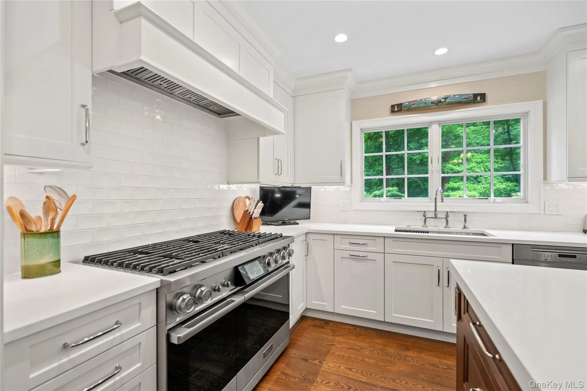 Large light filled Eat-in Kitchen with an oversized quartz island, WiFi-enabled Dacor range with steam oven, large Sub-Zero refrigerator, separate Sub Zero wine storage and Miele dishwasher. Large light filled Eat-in Kitchen with an oversized quartz island, WiFi-enabled Dacor range with steam oven, large Sub-Zero refrigerator, separate Sub Zero wine storage and Miele dishwasher.