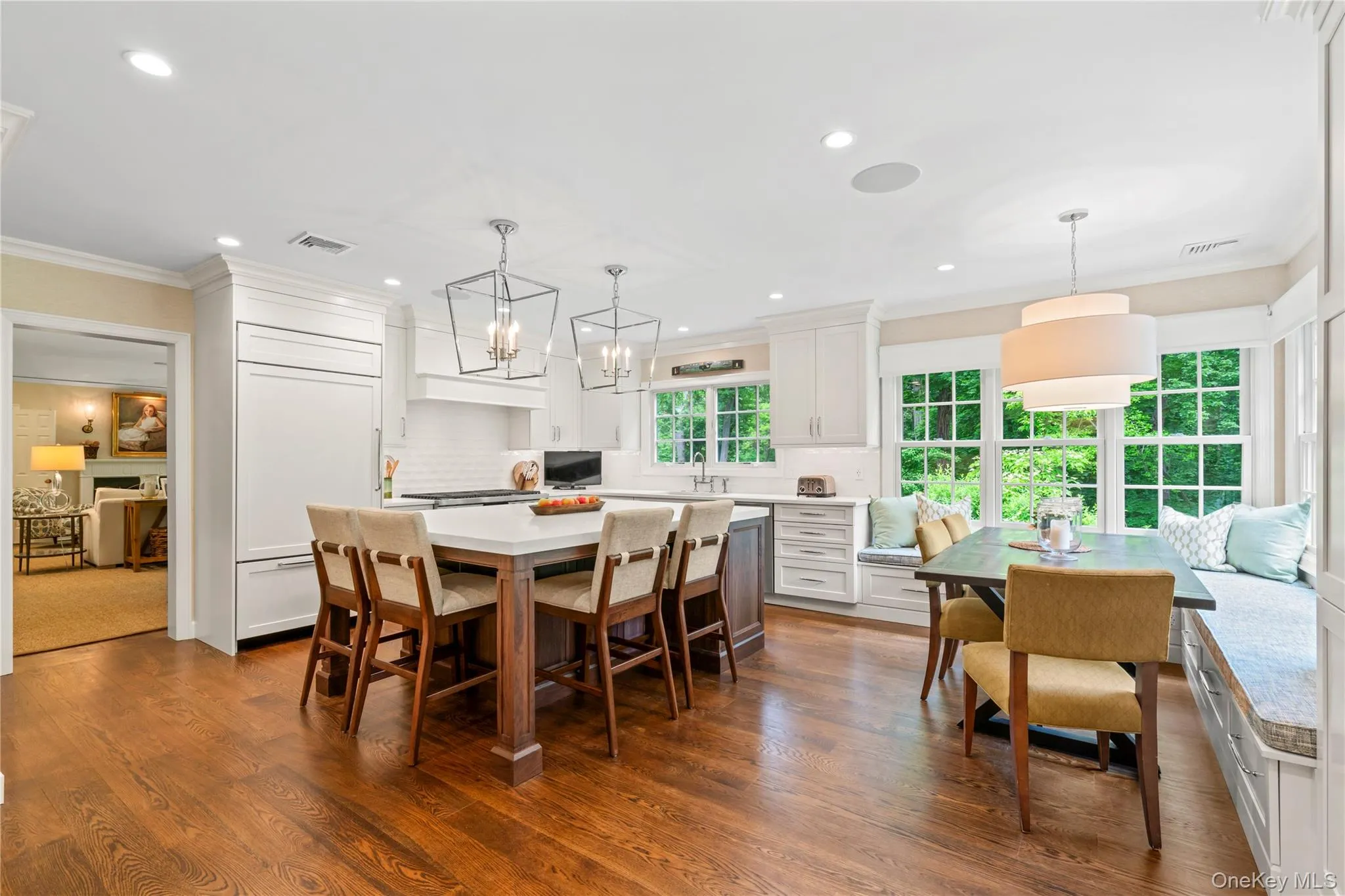Dining area with crown molding, dark wood-style floors, recessed lighting, and a chandelier Dining area with crown molding, dark wood-style floors, recessed lighting, and a chandelier