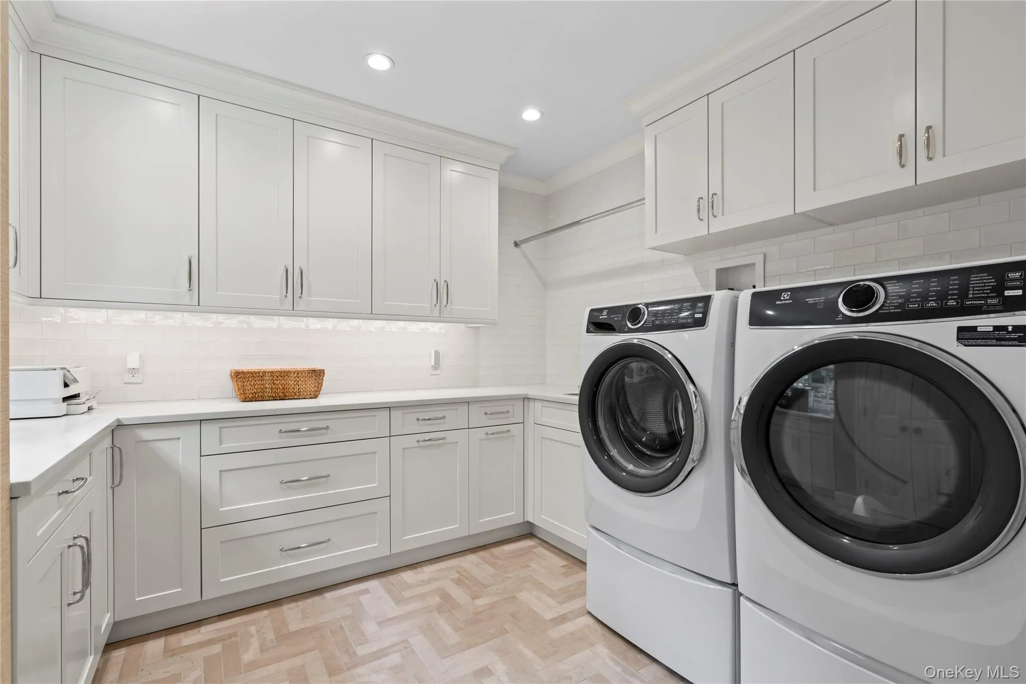 Laundry room featuring separate washer and dryer, cabinet space, recessed lighting, and ornamental molding Laundry room featuring separate washer and dryer, cabinet space, recessed lighting, and ornamental molding