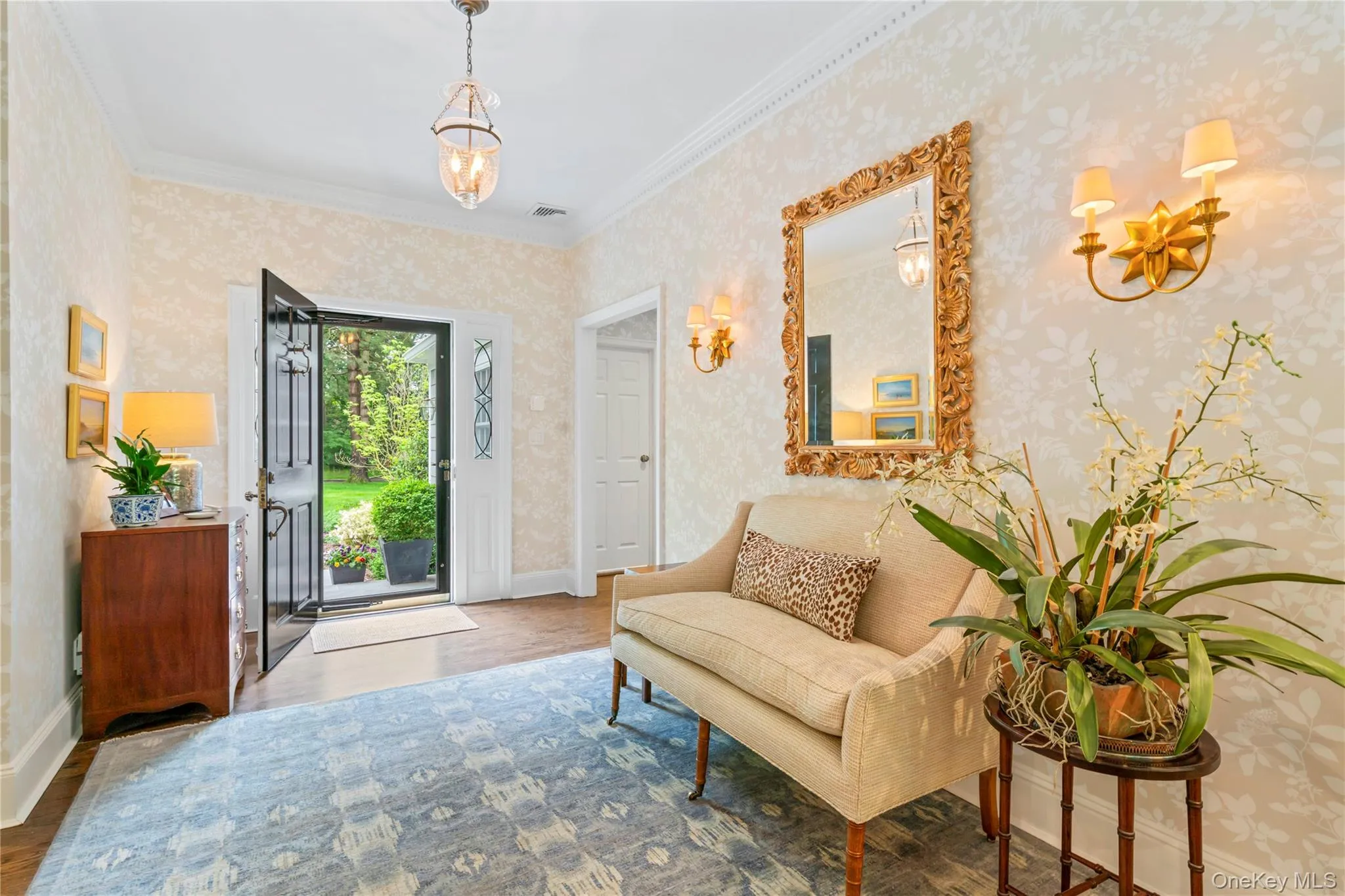 Spacious entrance foyer with wallpapered walls, wood finished floors, crown molding leading to the entertaining spaces. Spacious entrance foyer with wallpapered walls, wood finished floors, crown molding leading to the entertaining spaces.
