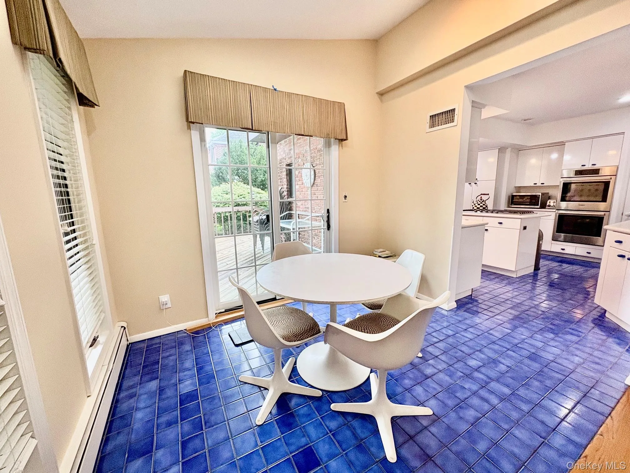 Breakfast room from kitchen, sliding doors leading out to oversized wood deck and step down to adjoining family Breakfast room from kitchen, sliding doors leading out to oversized wood deck and step down to adjoining family