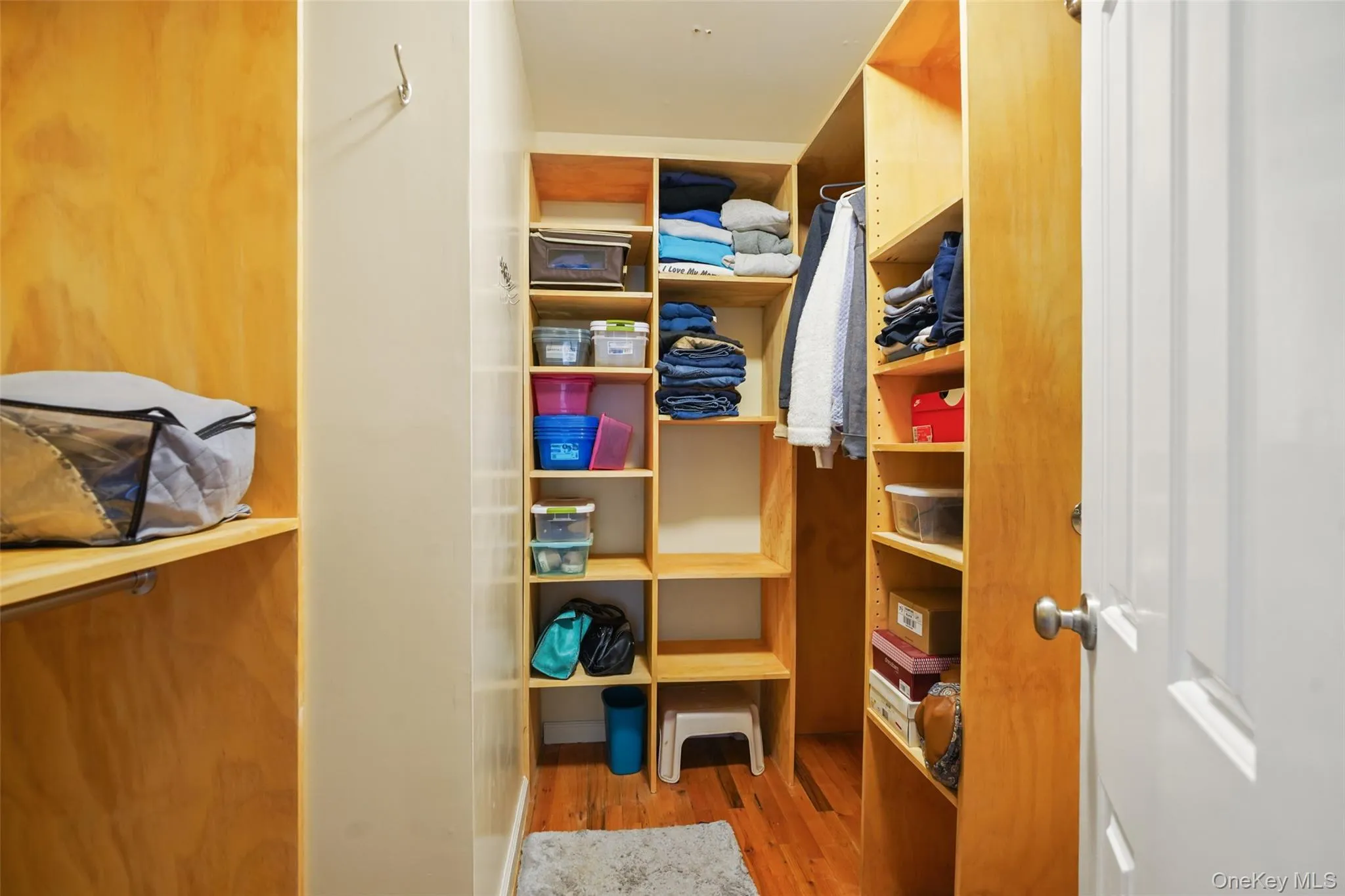 Primary Bedroom walk-in closet with custom built-ins. Primary Bedroom walk-in closet with custom built-ins.