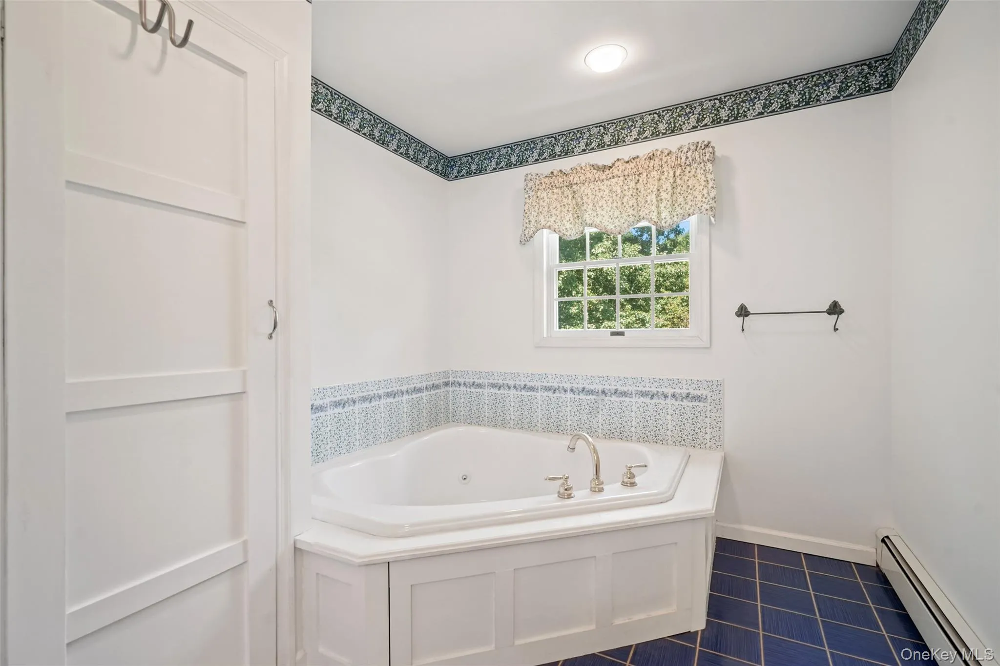 Large jacuzzi tub and tiled floors. Large jacuzzi tub and tiled floors.
