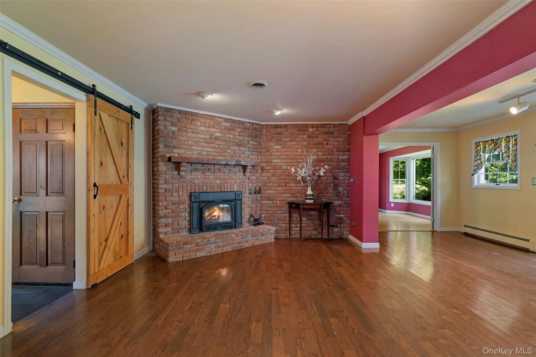 With brick hearth, wood-burning fireplace, handmade barn door with handmade hardware. With brick hearth, wood-burning fireplace, handmade barn door with handmade hardware.
