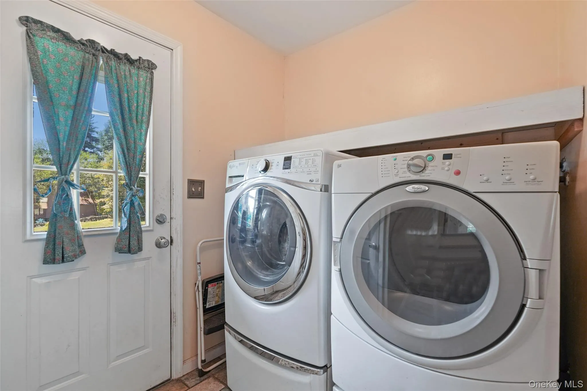 Laundry room with access to front of home and garage Laundry room with access to front of home and garage