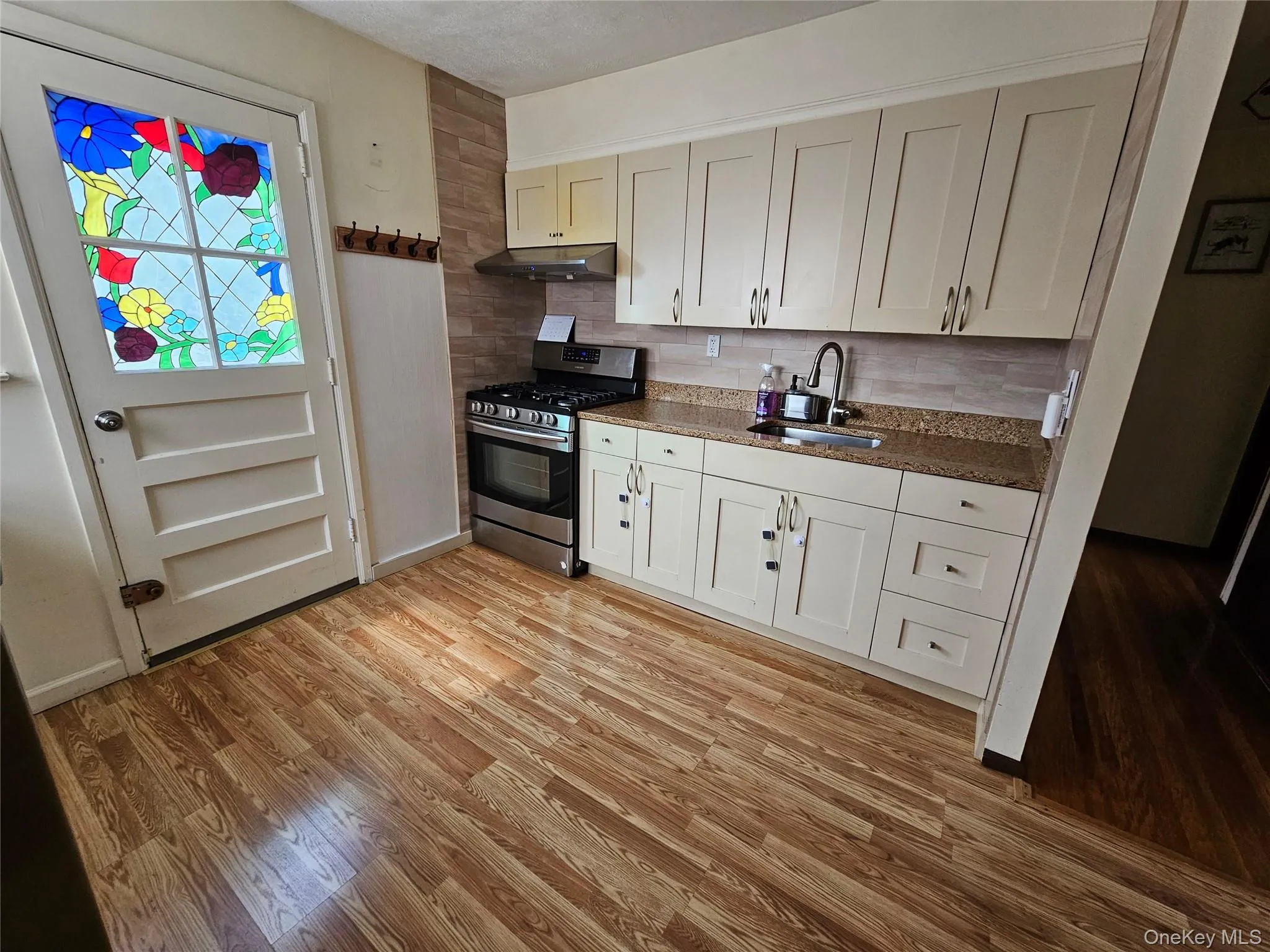 Renovated kitchen with backyard access. Renovated kitchen with backyard access.