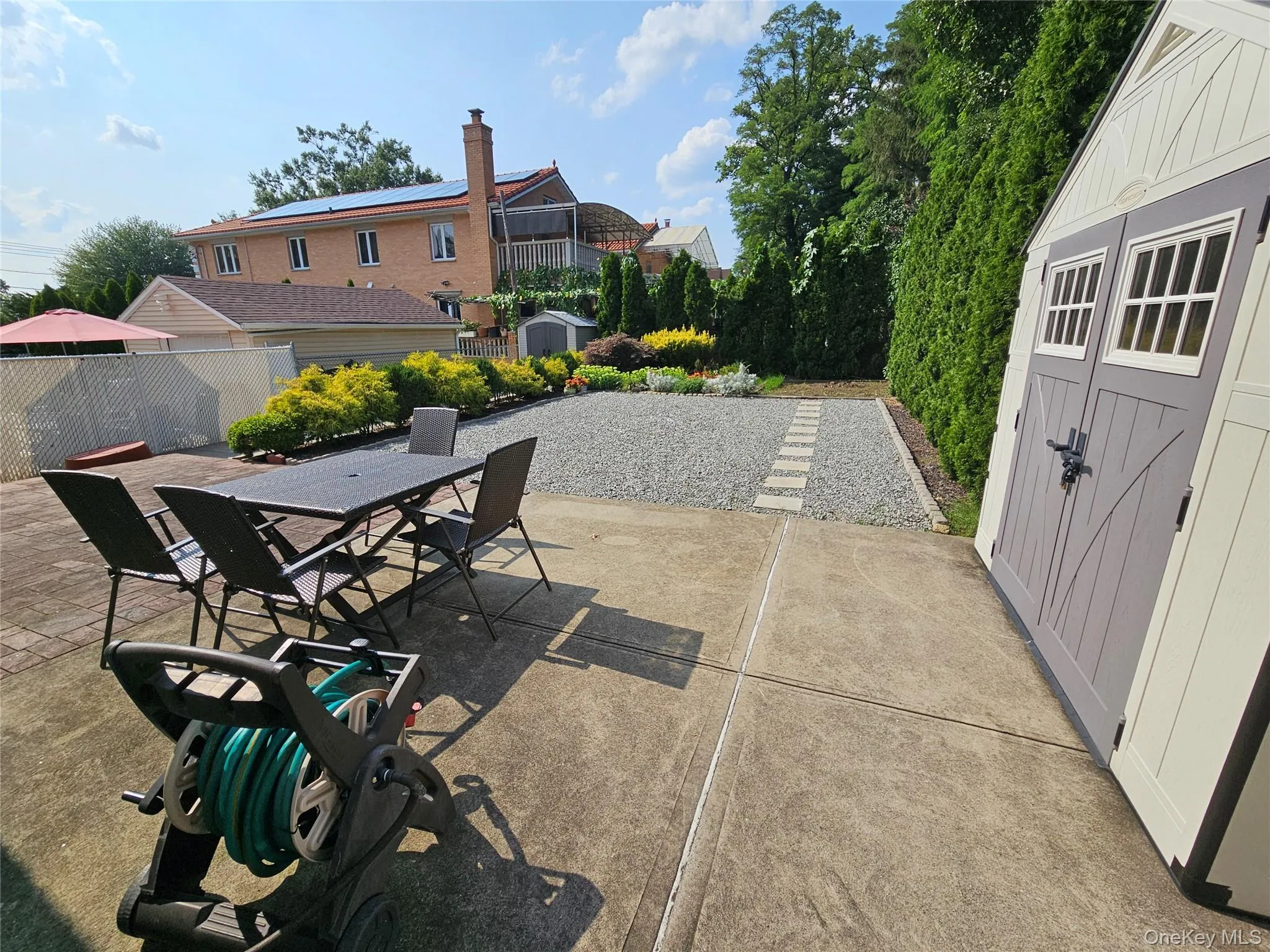 Backyard with 2 storage sheds Backyard with 2 storage sheds