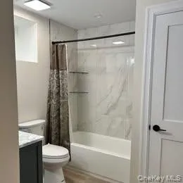 Tub and shower, linen closet, window Tub and shower, linen closet, window