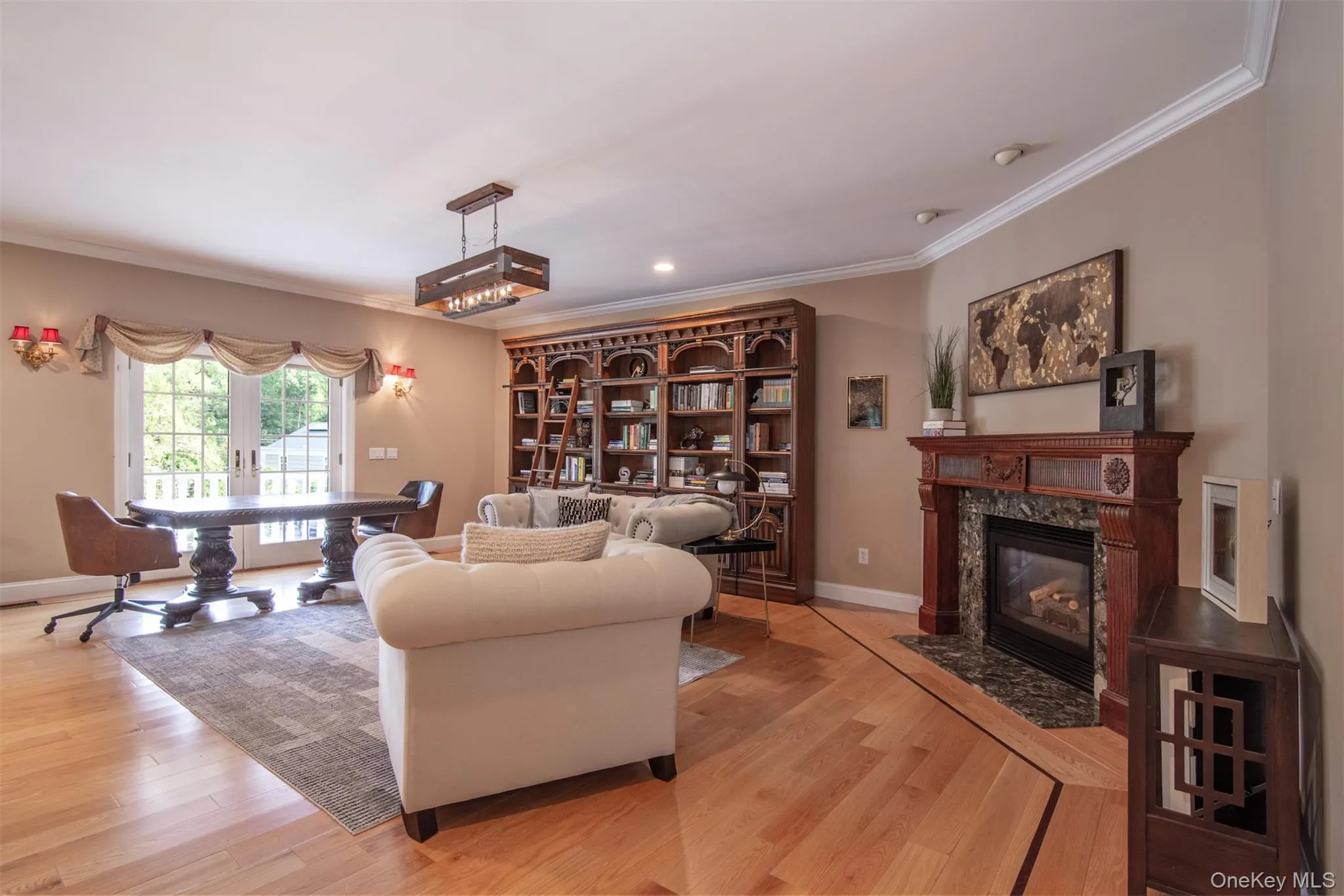 Library with fireplace and French doors out to the front porch Library with fireplace and French doors out to the front porch