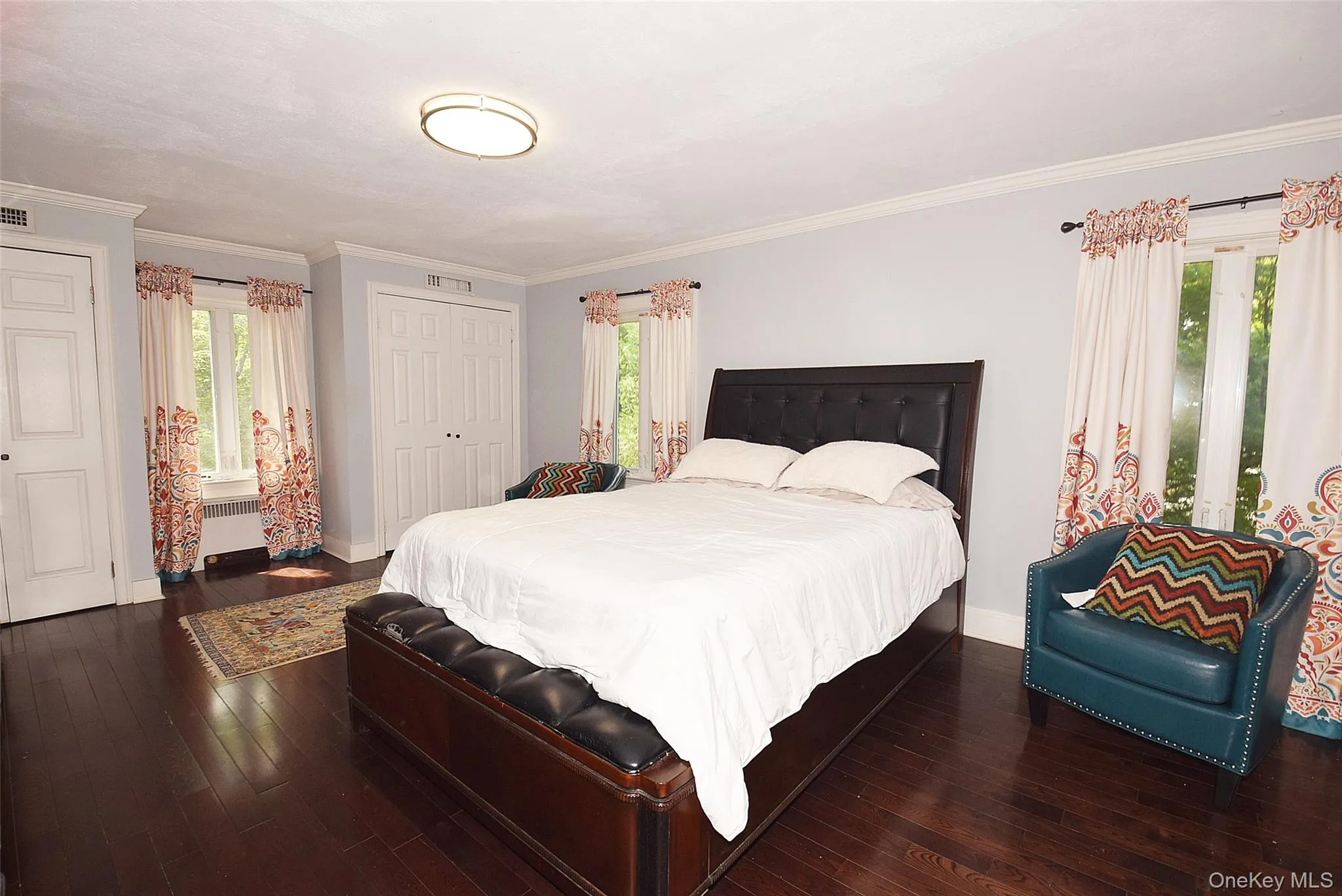 Hardwood flooring, crown molding, double bi-fold closet doors, and two windows with trim Hardwood flooring, crown molding, double bi-fold closet doors, and two windows with trim