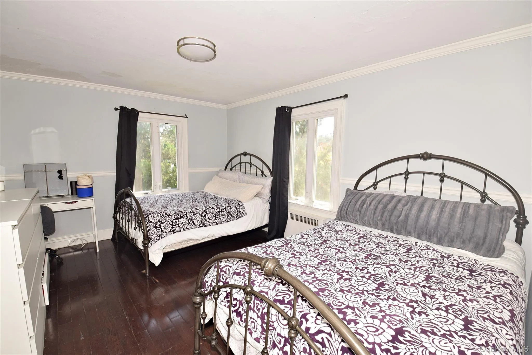 Wood-finish flooring, light blue and white wall color, white crown molding, recessed lighting, and large windows Wood-finish flooring, light blue and white wall color, white crown molding, recessed lighting, and large windows