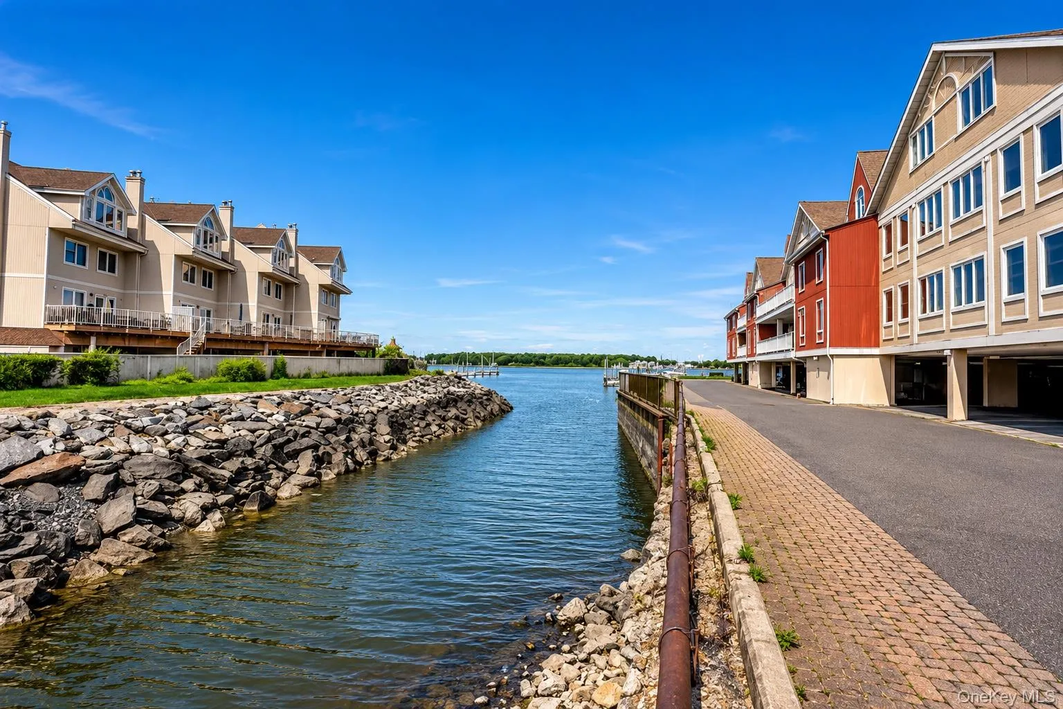 Waterfront properties with direct water access, private balconies, and a brick paver walkway Waterfront properties with direct water access, private balconies, and a brick paver walkway
