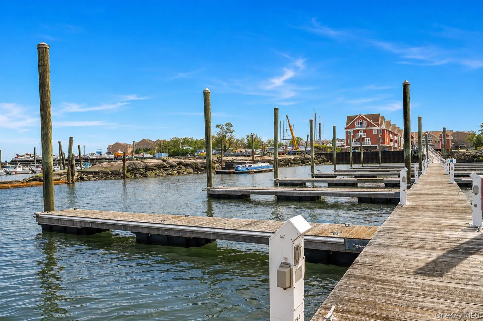 Wooden dock with multiple boat slips and pilings Wooden dock with multiple boat slips and pilings