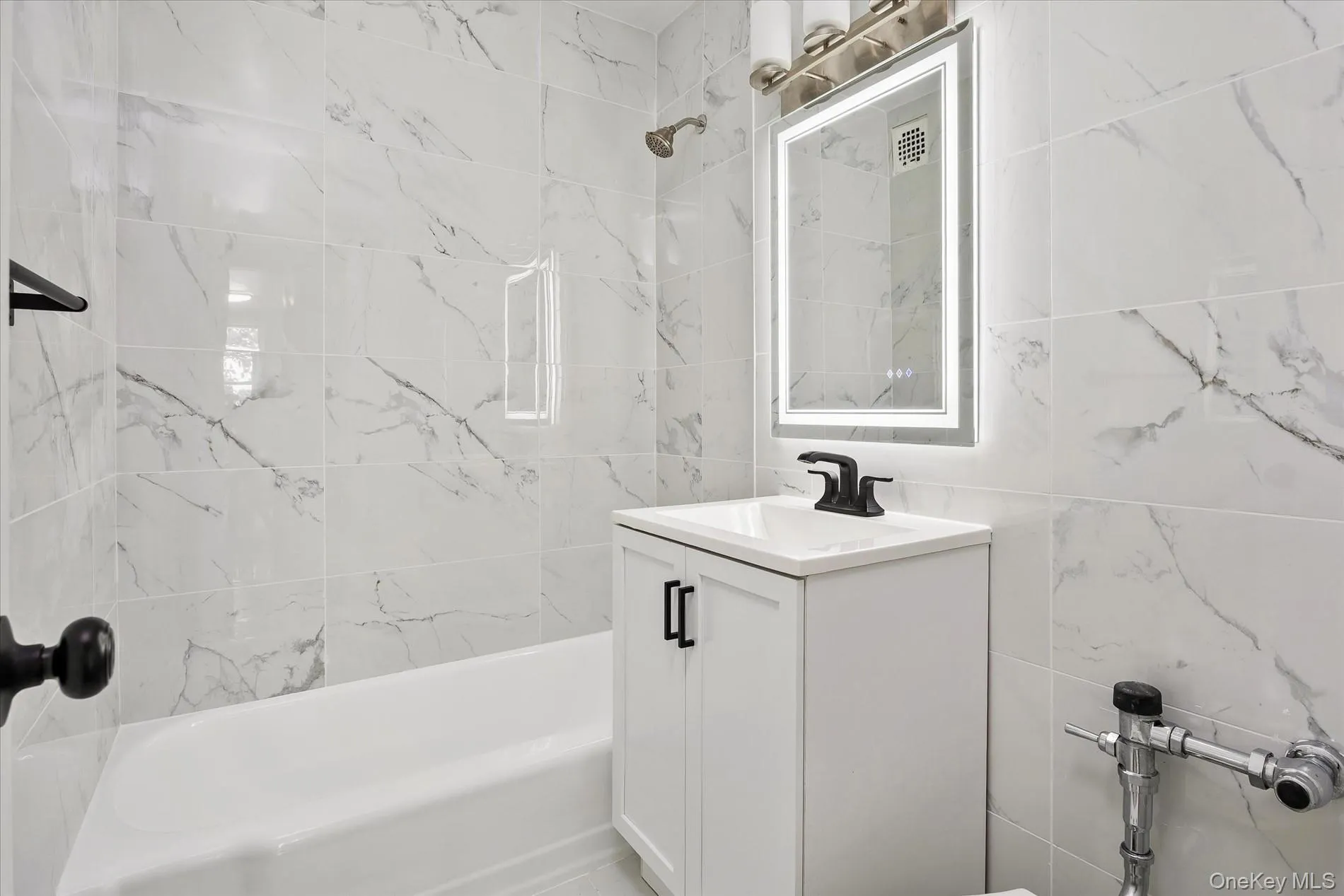 Full wall and shower surround featuring large format tile Full wall and shower surround featuring large format tile