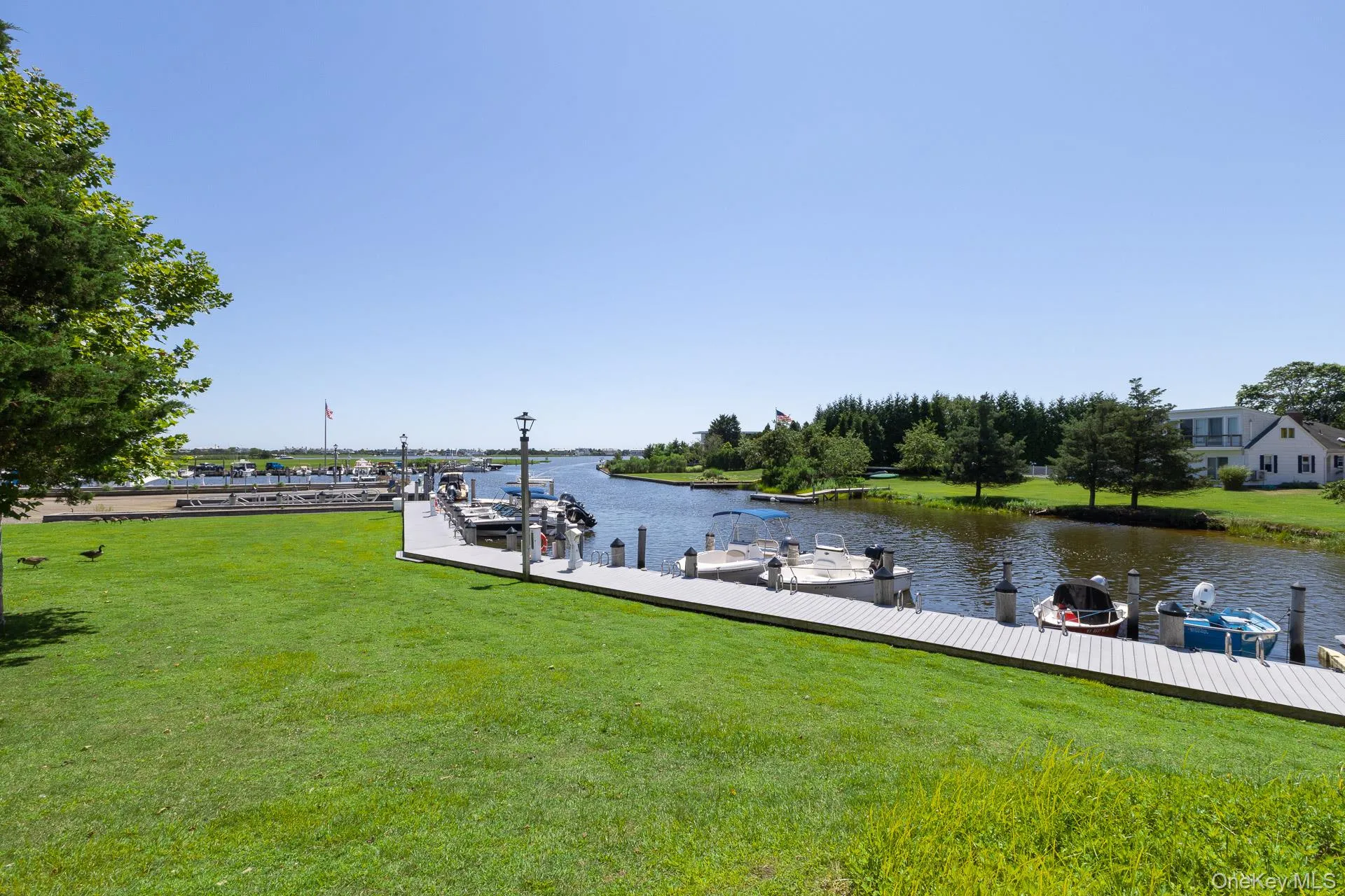 Expansive waterfront view featuring a multi-slip dock, and waterway access Expansive waterfront view featuring a multi-slip dock, and waterway access