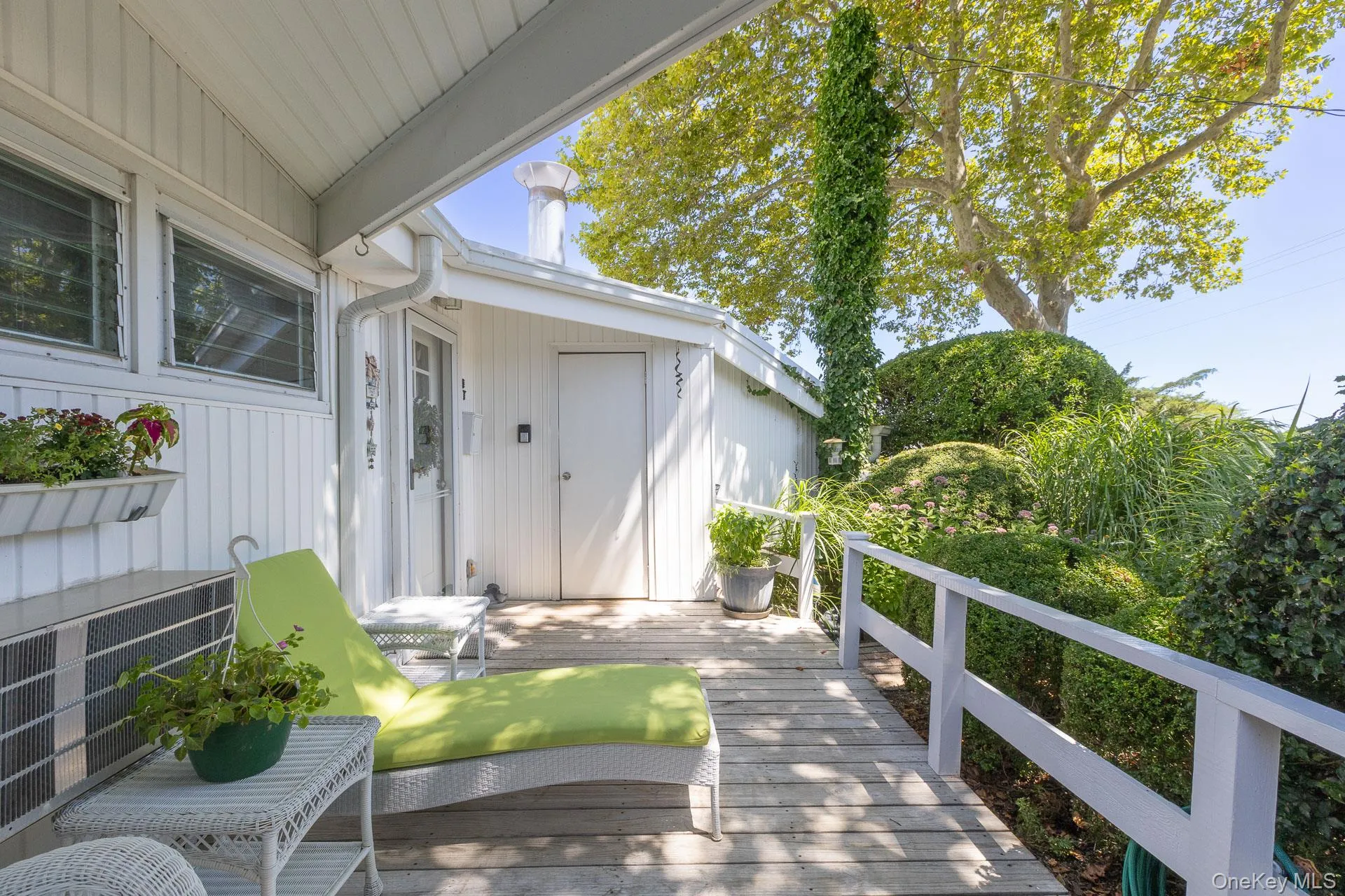 Bright, open-air deck featuring abundant natural light beneath a covered roof structure Bright, open-air deck featuring abundant natural light beneath a covered roof structure