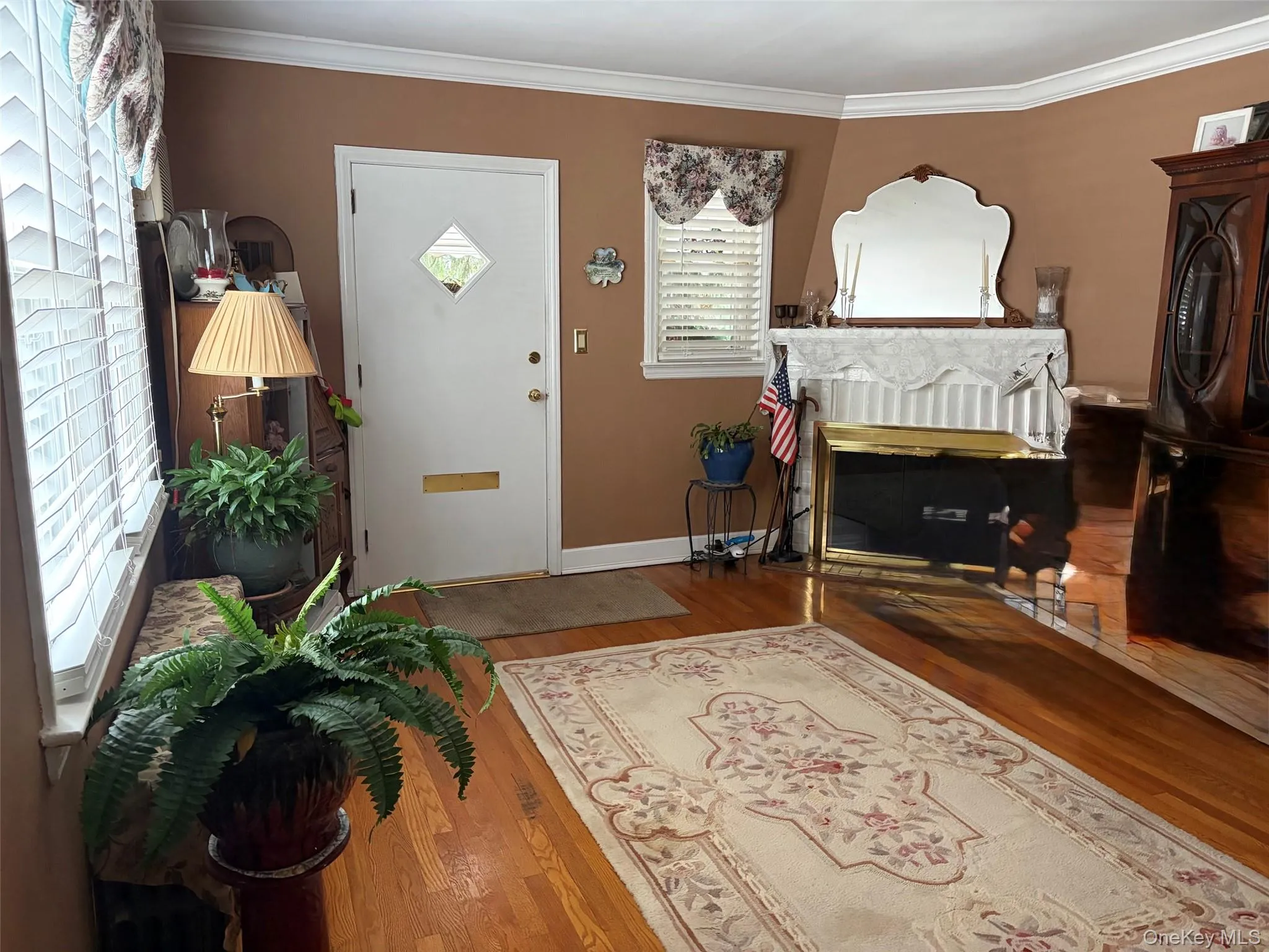 Living room with wood burning fireplace and wood flooring Living room with wood burning fireplace and wood flooring