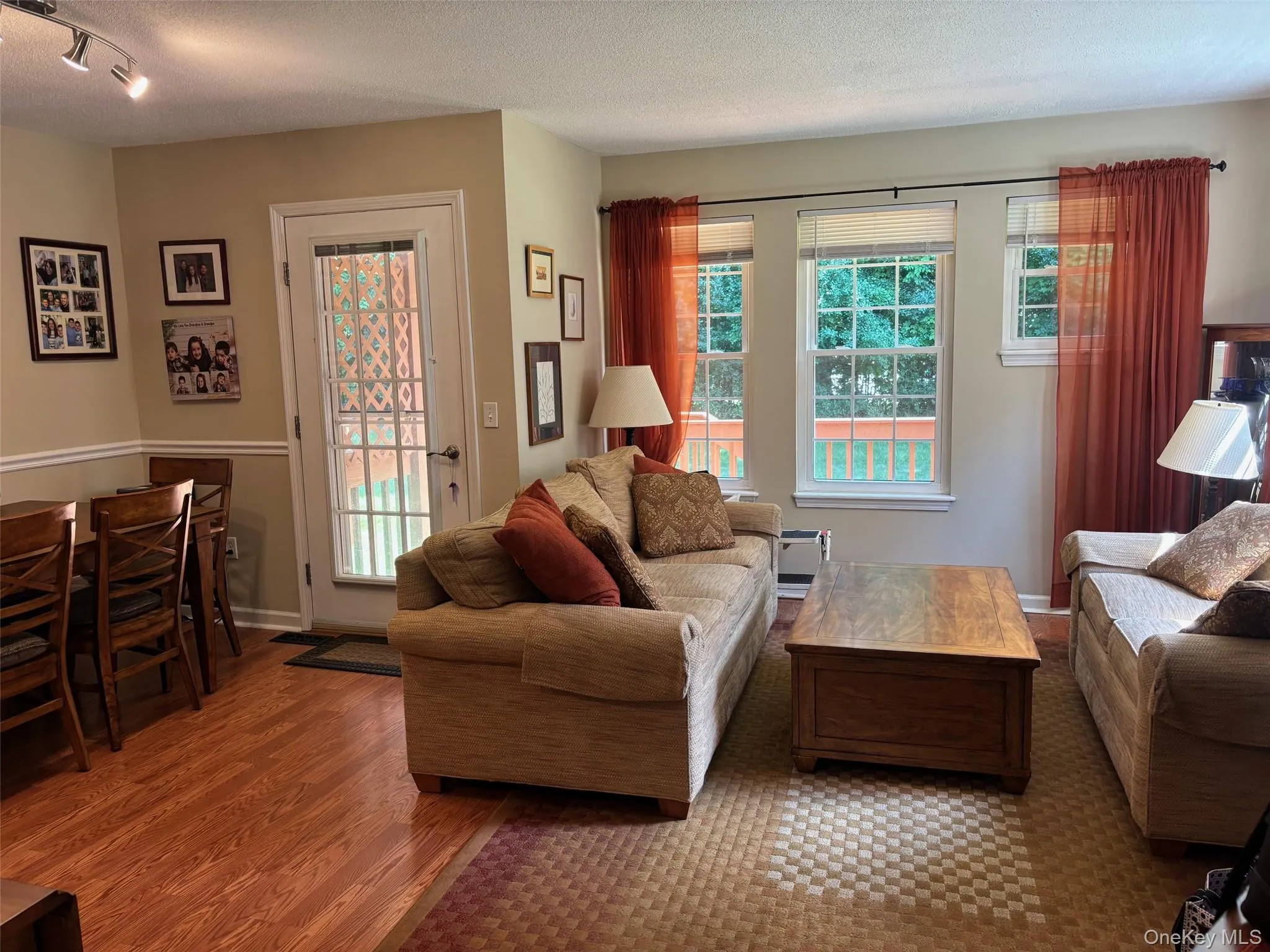 Living room with door to back deck. Living room with door to back deck.
