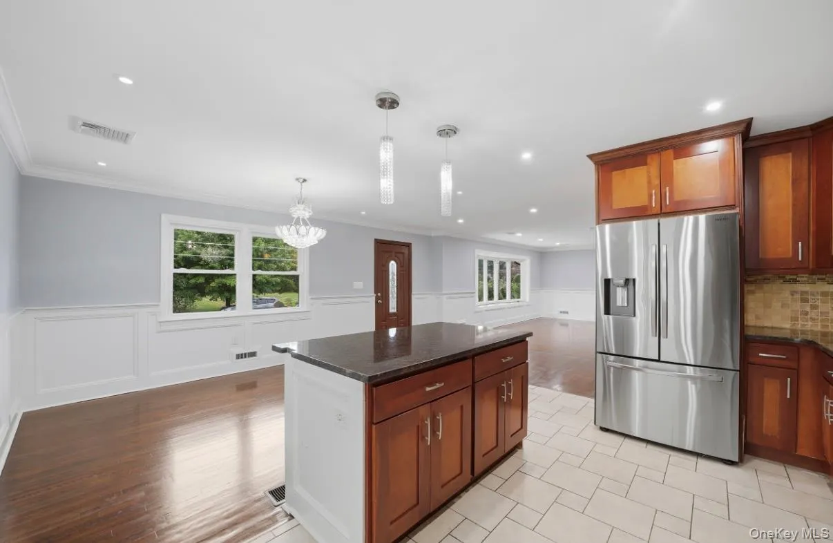Open concept kitchen and dining featuring large center island. Open concept kitchen and dining featuring large center island.
