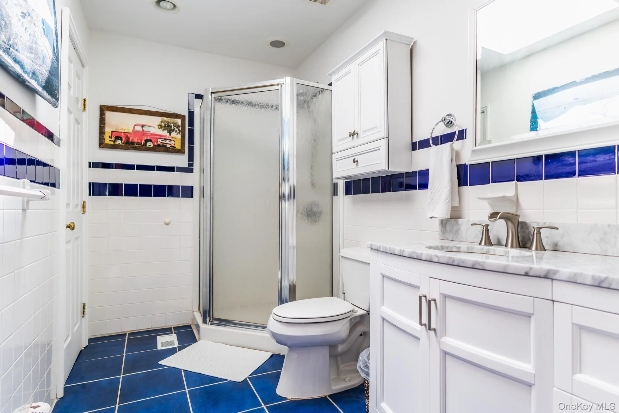 White vanity with a stone countertop, chrome faucet, and integrated sink White vanity with a stone countertop, chrome faucet, and integrated sink