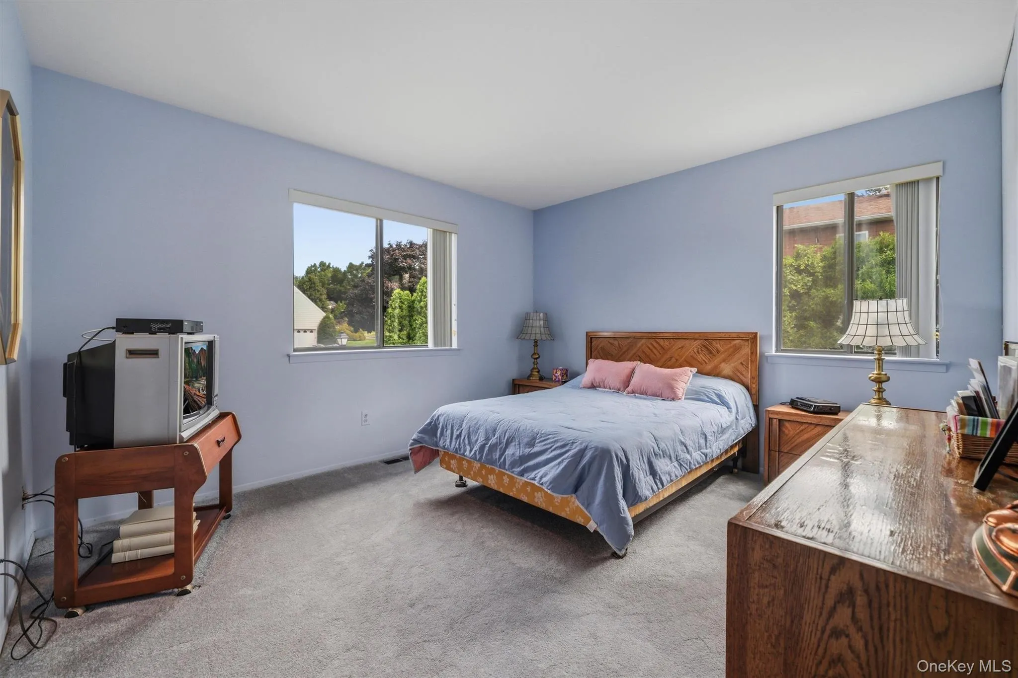 Second bedroom with two windows and a large double closet. Second bedroom with two windows and a large double closet.
