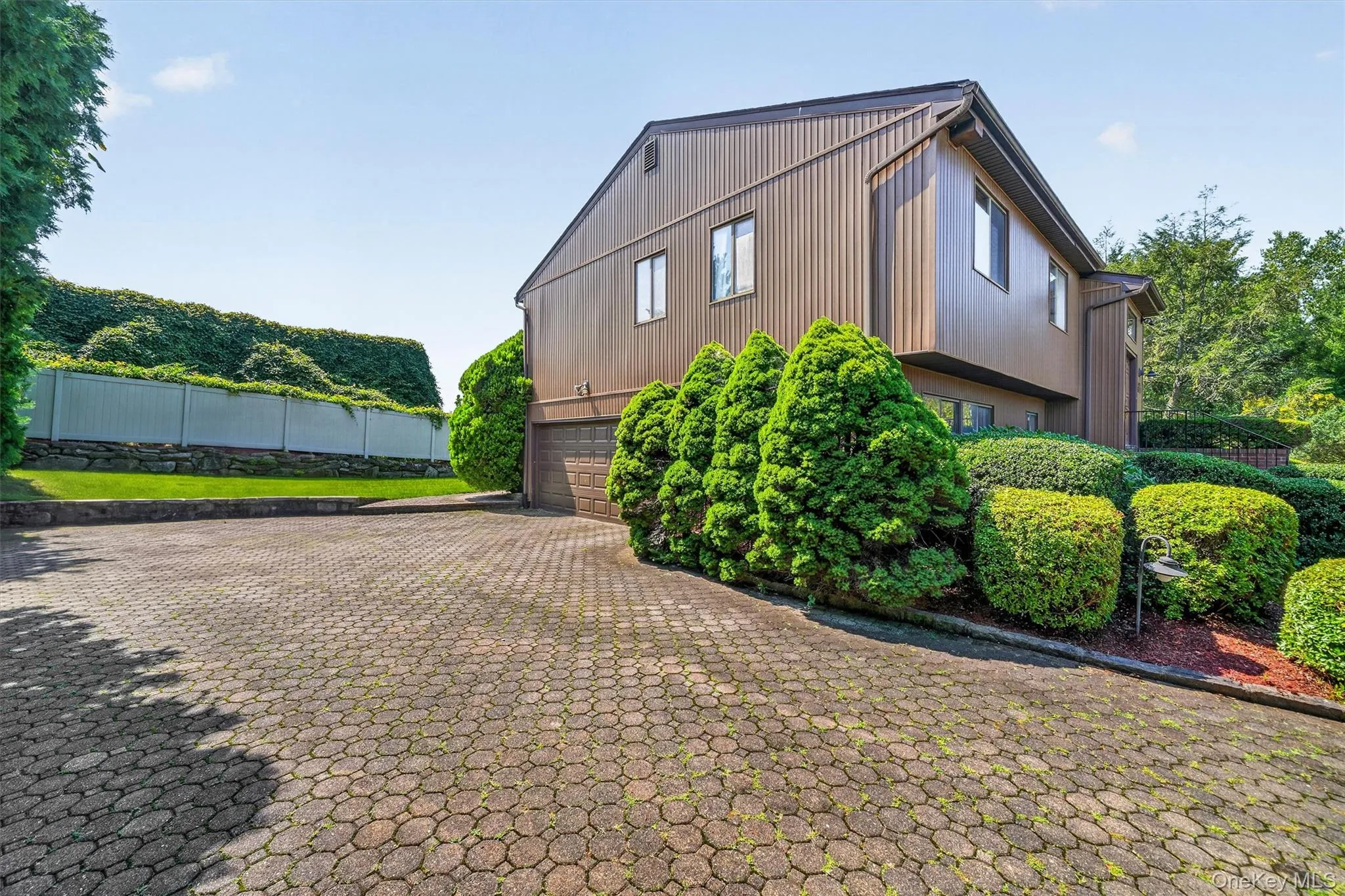 Paver driveway and attached two-car garage. Paver driveway and attached two-car garage.