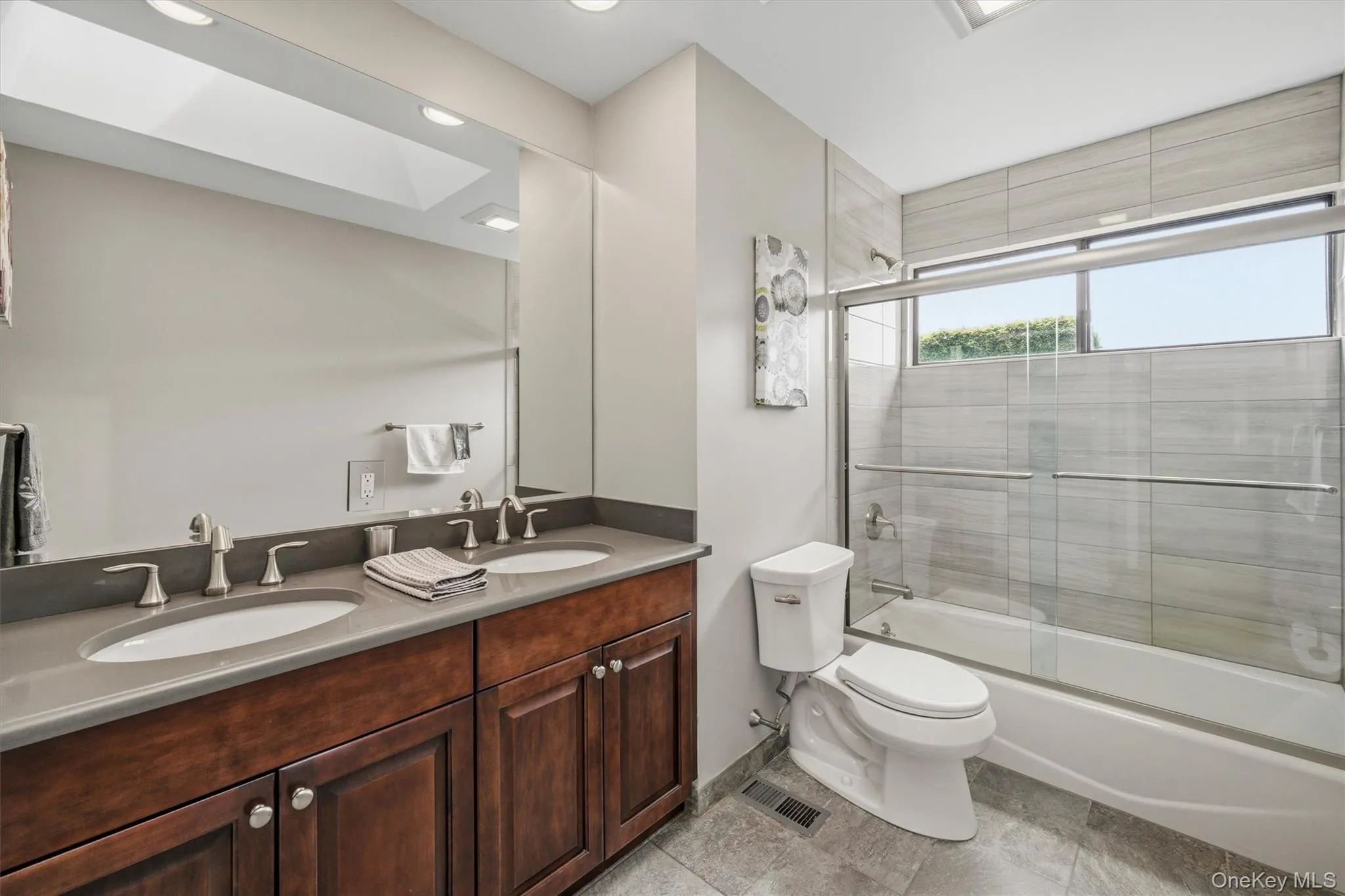 Hall bath with double vanity and shower with tub. Hall bath with double vanity and shower with tub.