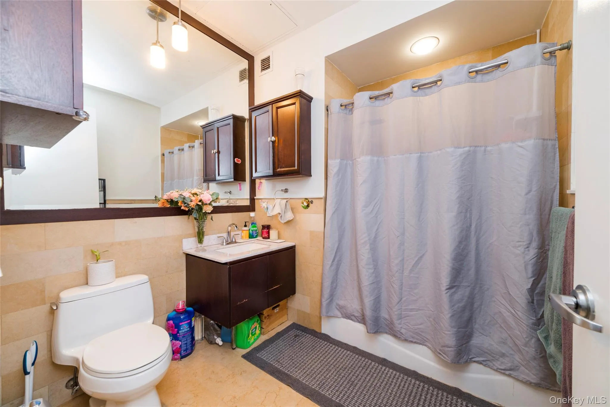 Modern full bathroom with sleek vanity & tiled shower/tub combo Modern full bathroom with sleek vanity & tiled shower/tub combo