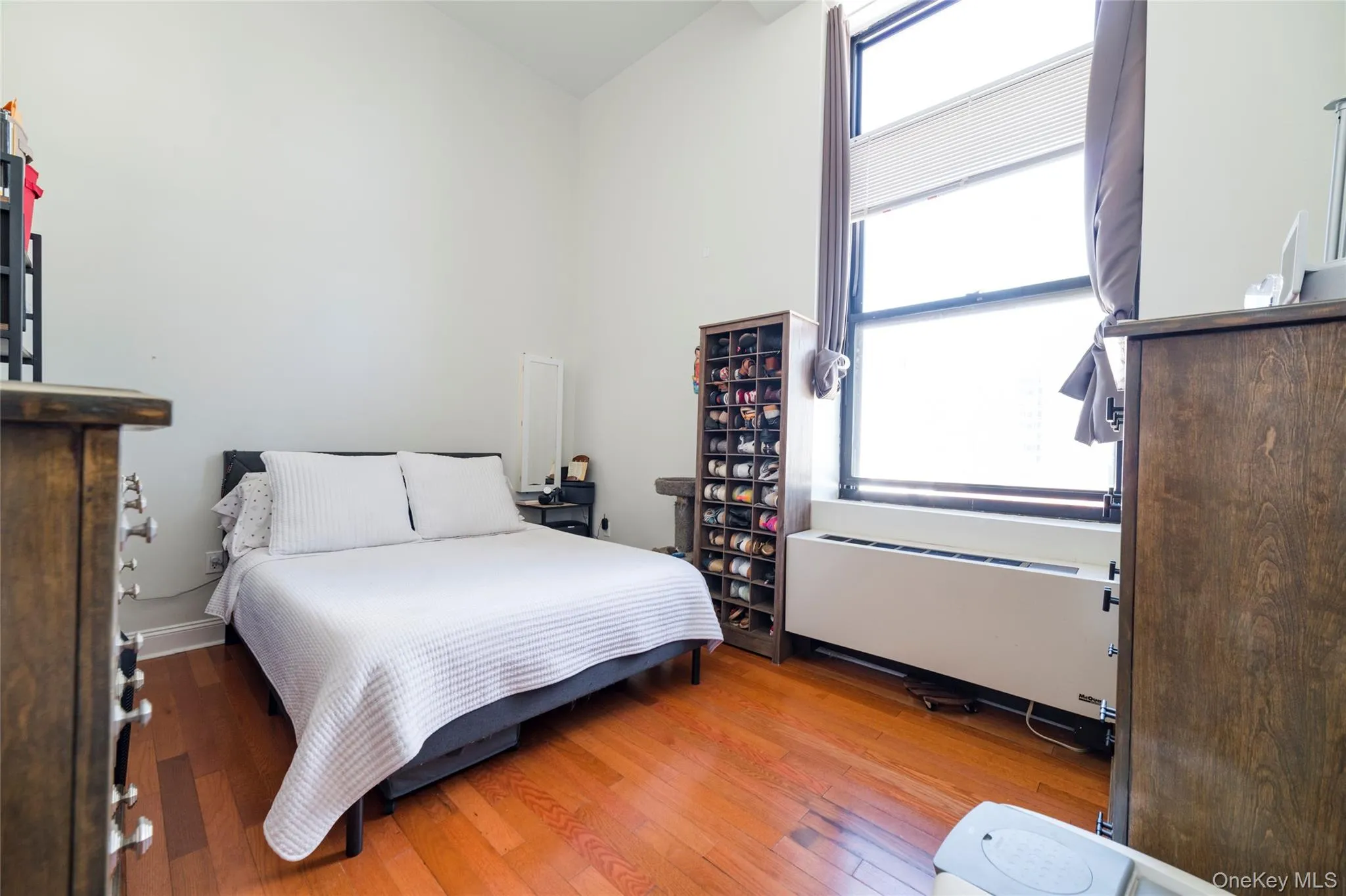 Bright bedroom with oversized windows featuring abundant natural light Bright bedroom with oversized windows featuring abundant natural light