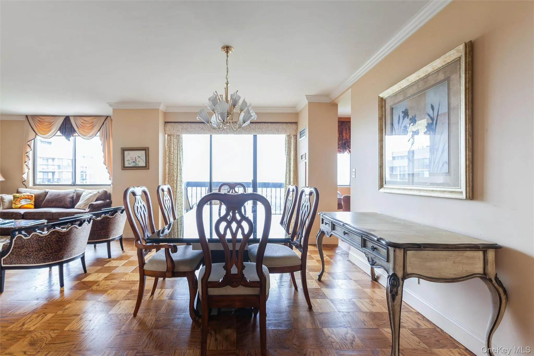 Hardwood flooring, crown molding, beautiful chandelier, and sliders to balcony Hardwood flooring, crown molding, beautiful chandelier, and sliders to balcony