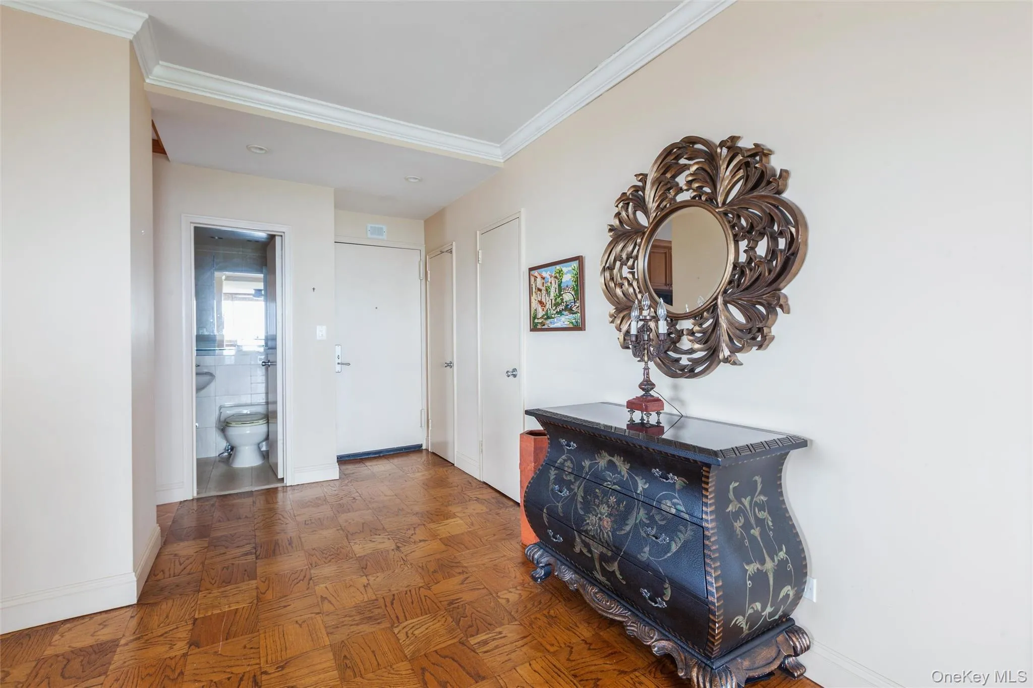 Parquet wood-finish flooring with crown molding, Coat closet and storage closet. Parquet wood-finish flooring with crown molding, Coat closet and storage closet.