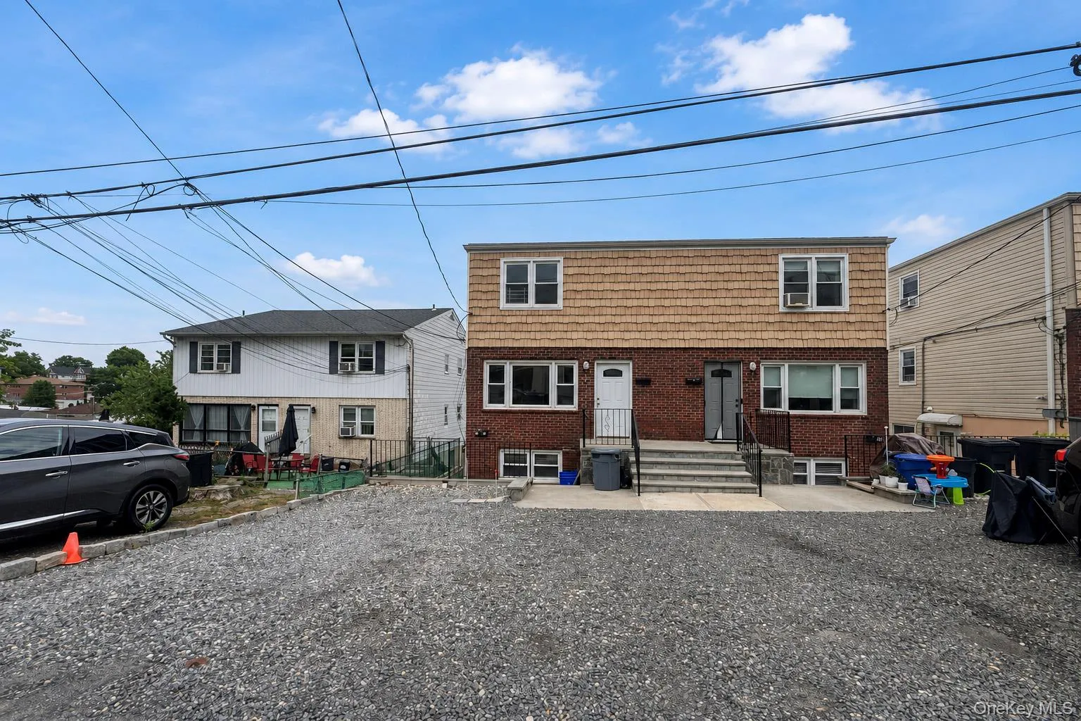 Red brick facade with shake siding Red brick facade with shake siding