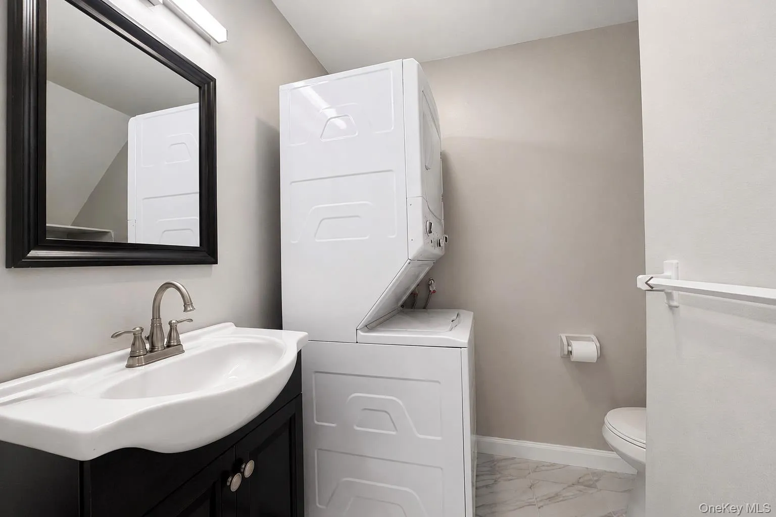 Wall-mounted vanity with integrated sink, brushed nickel faucet, and framed mirror Wall-mounted vanity with integrated sink, brushed nickel faucet, and framed mirror