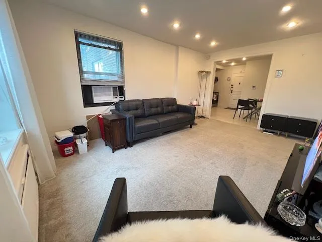 Living area with carpet floors, recessed lighting, and cooling unit Living area with carpet floors, recessed lighting, and cooling unit