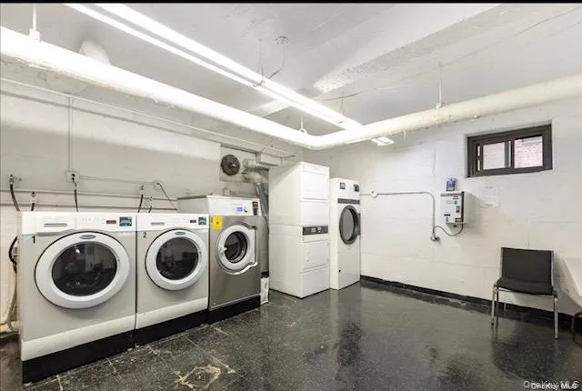 Basement Community laundry with washing machine and dryer and stacked washing machine and dryer Basement Community laundry with washing machine and dryer and stacked washing machine and dryer