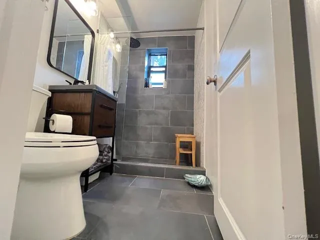 Full bathroom with tiled shower and vanity Full bathroom with tiled shower and vanity