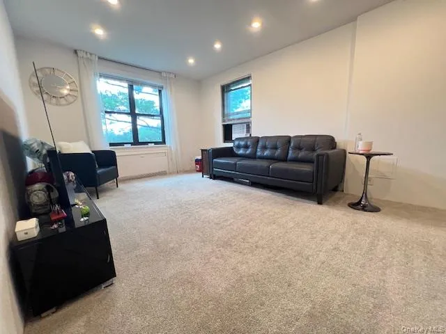 Carpeted living room featuring recessed lighting Carpeted living room featuring recessed lighting
