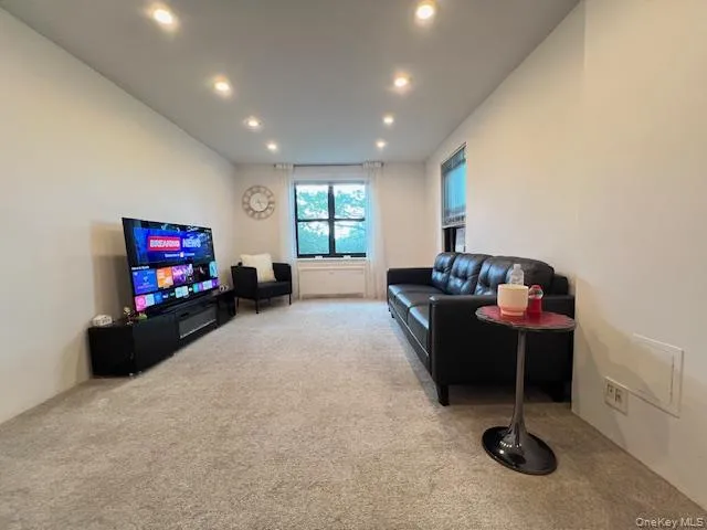 Living room featuring carpet flooring and recessed lighting Living room featuring carpet flooring and recessed lighting