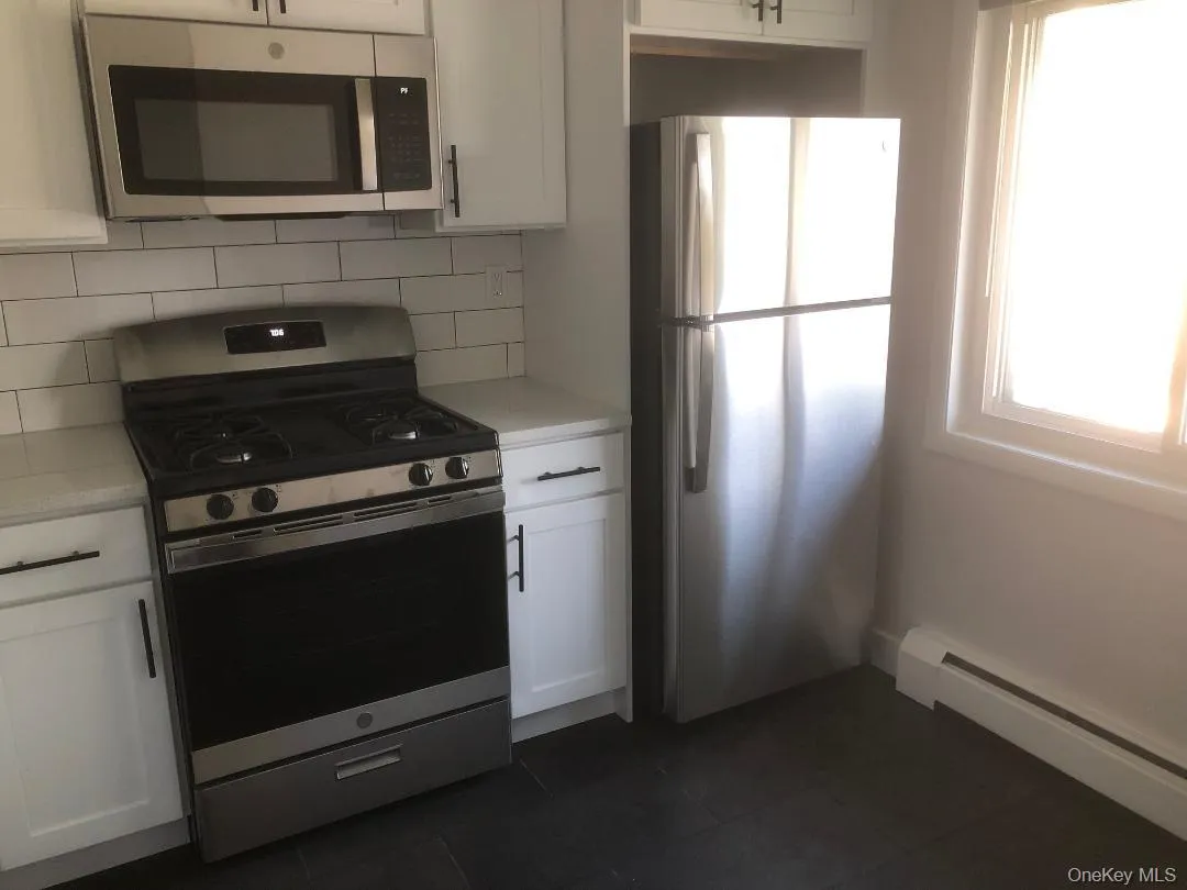 Kitchen featuring stainless steel appliances including a refrigerator, gas range, dishwasher and over-the-range microwave Kitchen featuring stainless steel appliances including a refrigerator, gas range, dishwasher and over-the-range microwave
