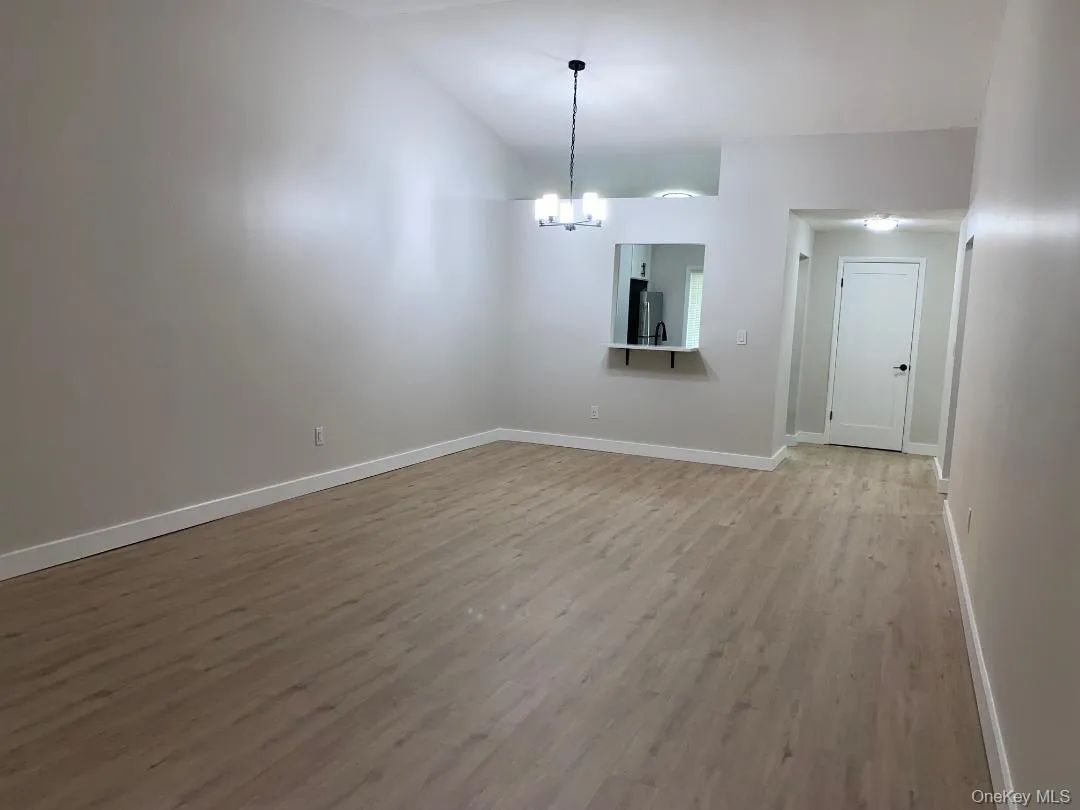 Huge living room with dramatic cathedral ceiling which opens to the dining area and the eat in kitchen Huge living room with dramatic cathedral ceiling which opens to the dining area and the eat in kitchen
