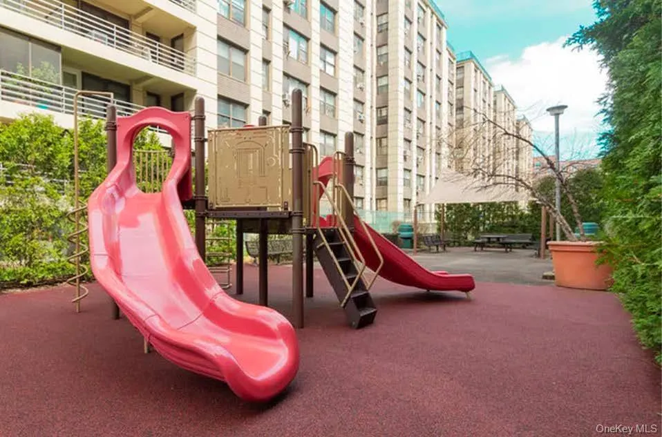 Recreational area featuring a playground with slides, shade structure, and picnic tables Recreational area featuring a playground with slides, shade structure, and picnic tables