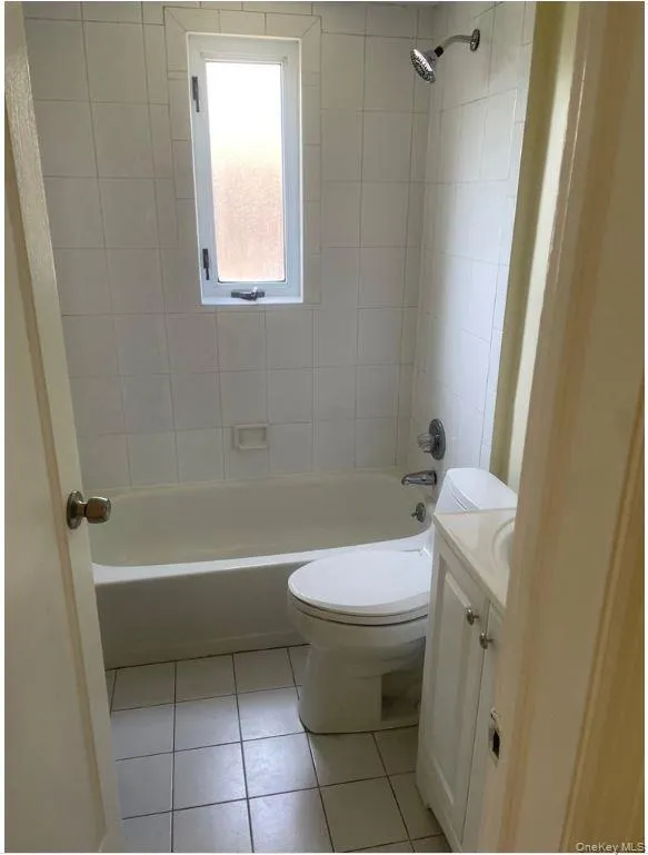 Full bath with vanity, tile patterned flooring, and shower / tub combination Full bath with vanity, tile patterned flooring, and shower / tub combination