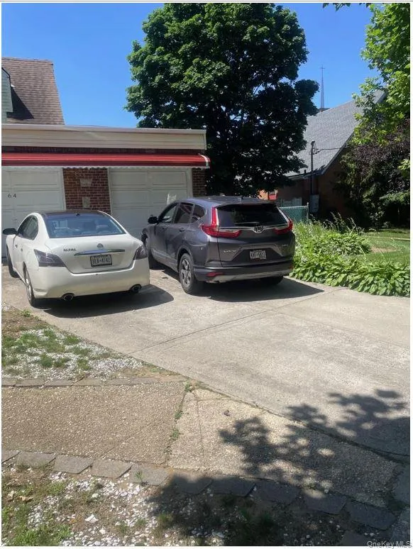 View of property exterior with an attached garage, concrete driveway, and brick siding View of property exterior with an attached garage, concrete driveway, and brick siding
