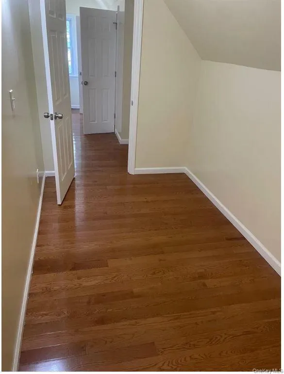 Hall with wood finished floors and baseboards Hall with wood finished floors and baseboards